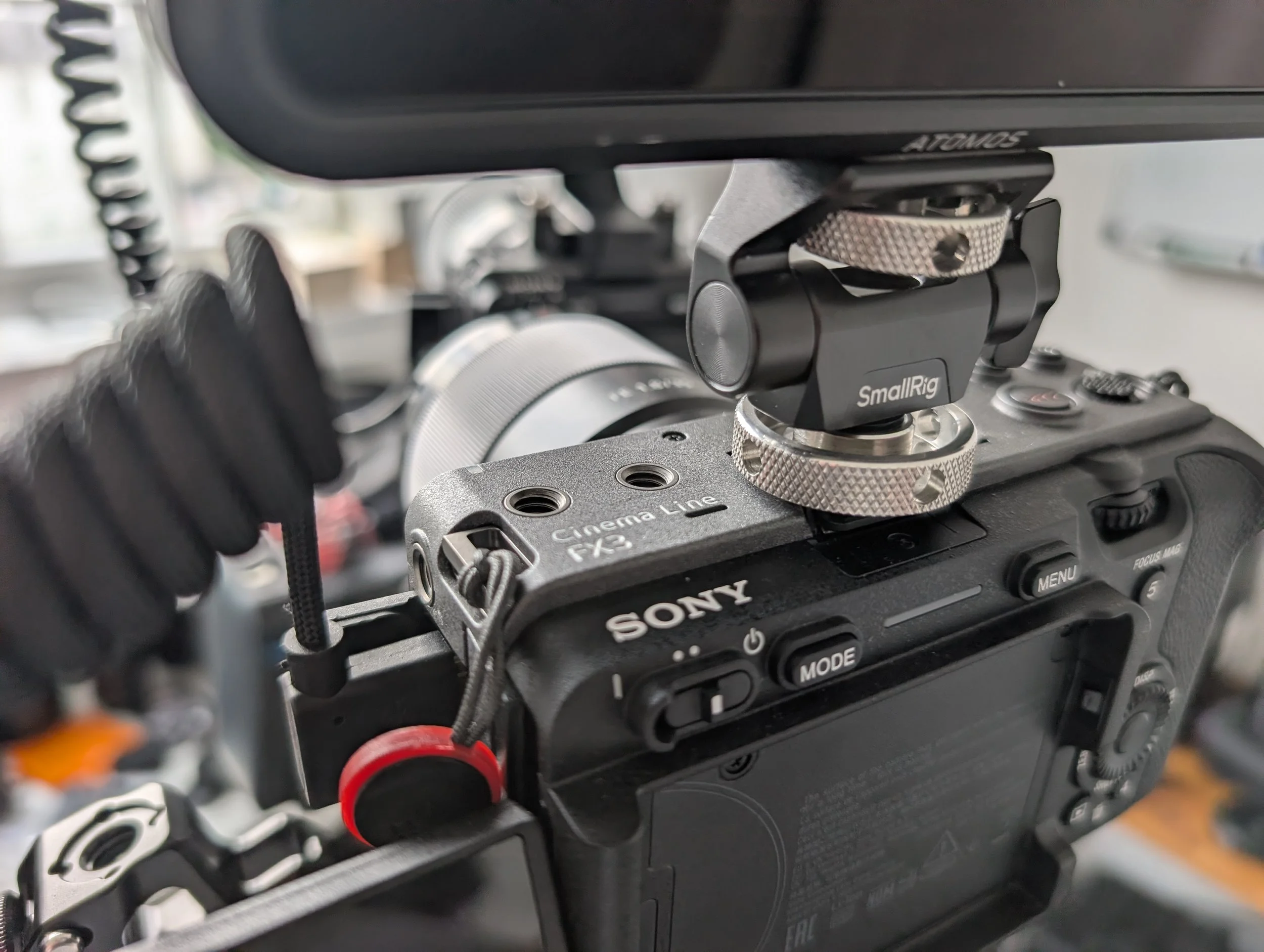 Close-up of a camera mounted on a professional camera rig with various adjustment knobs and components.