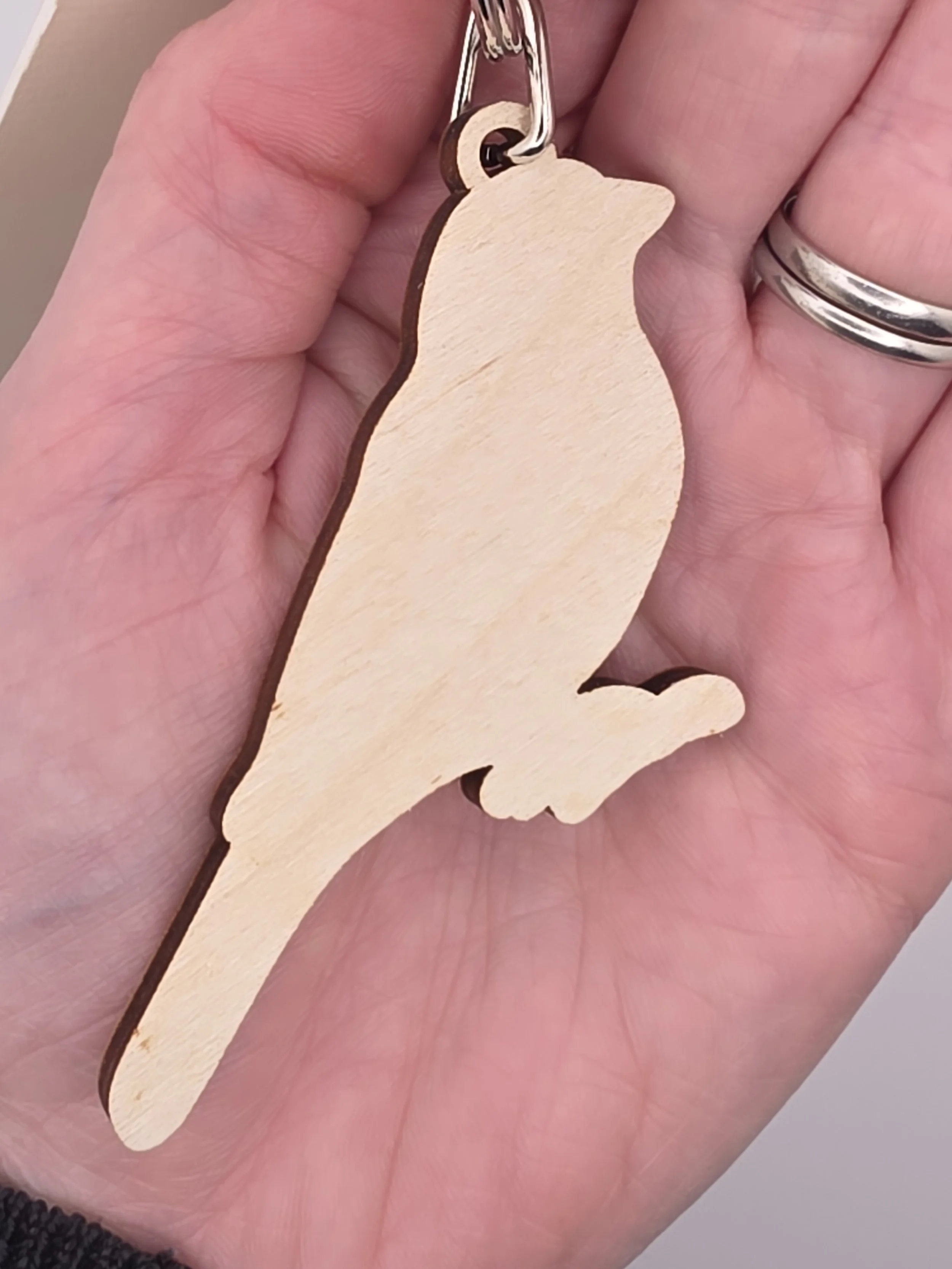 Back view of Eurasian Tree Sparrow wooden keyring showing plain birch wood finish and silver keyring fitting