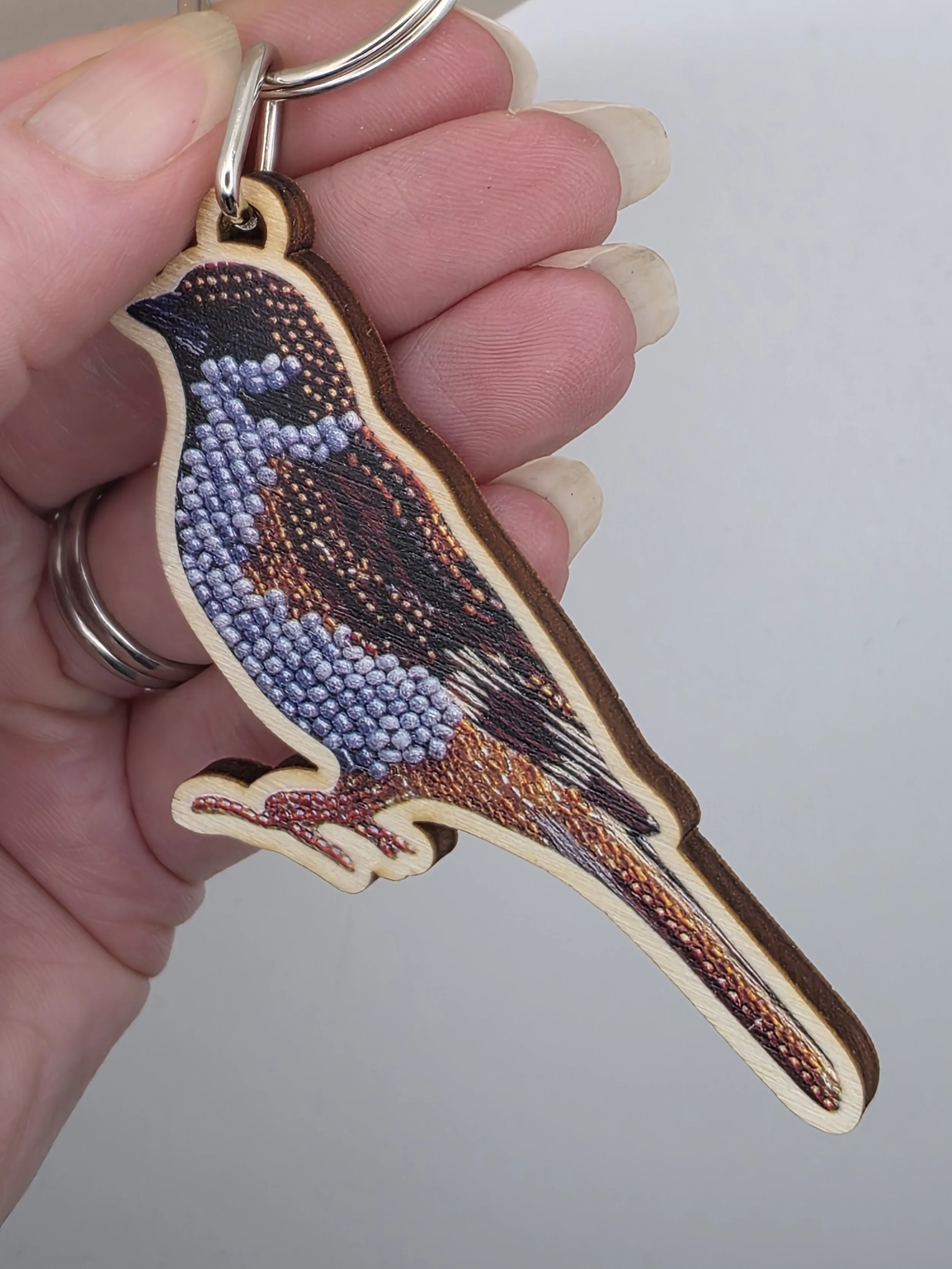 Eurasian Tree Sparrow keyring in hand from side angle to show size and wood thickness