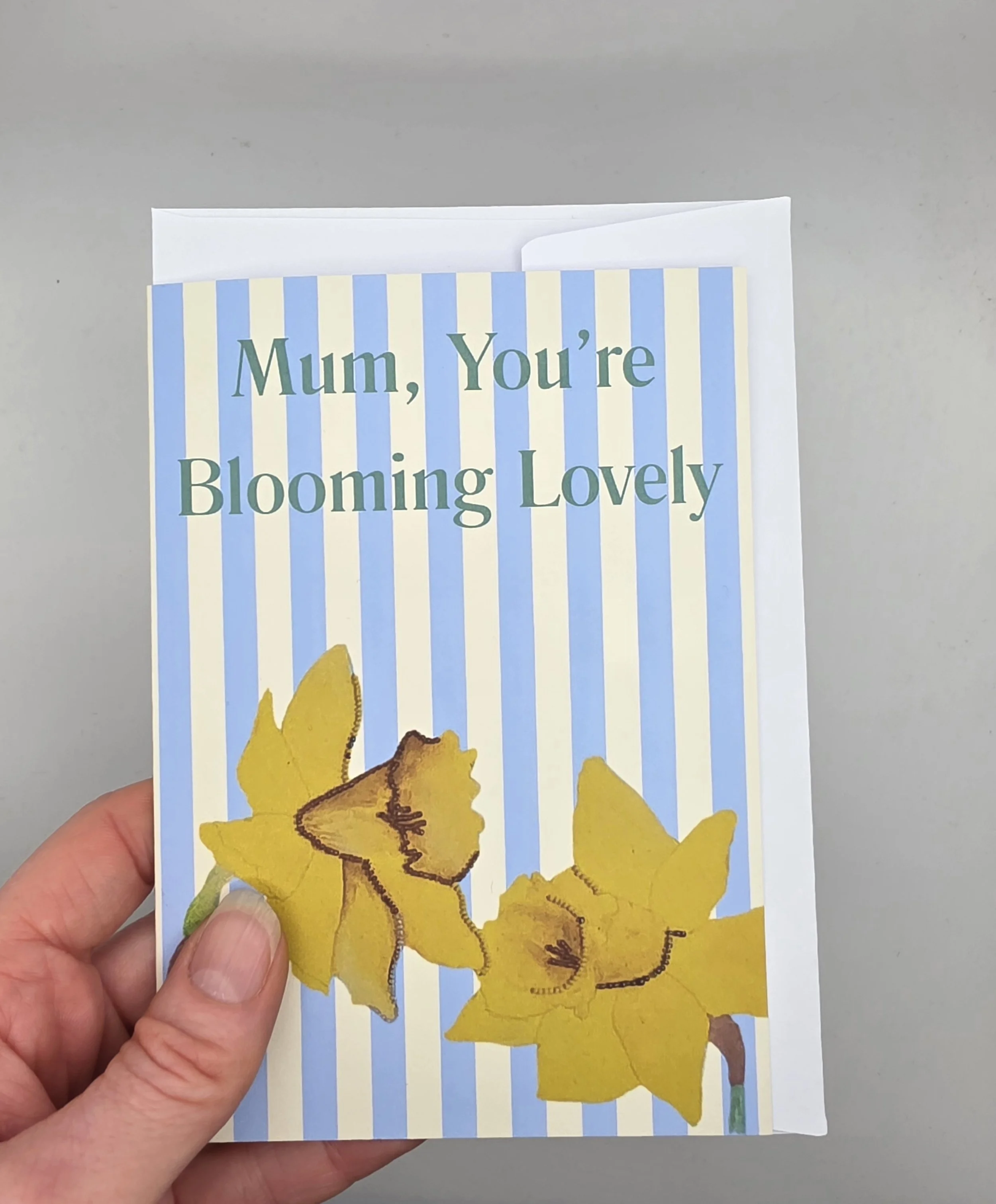 Floral Mother’s Day greeting card for Mum, daffodil design, blue and cream stripes, A6 size with envelope.