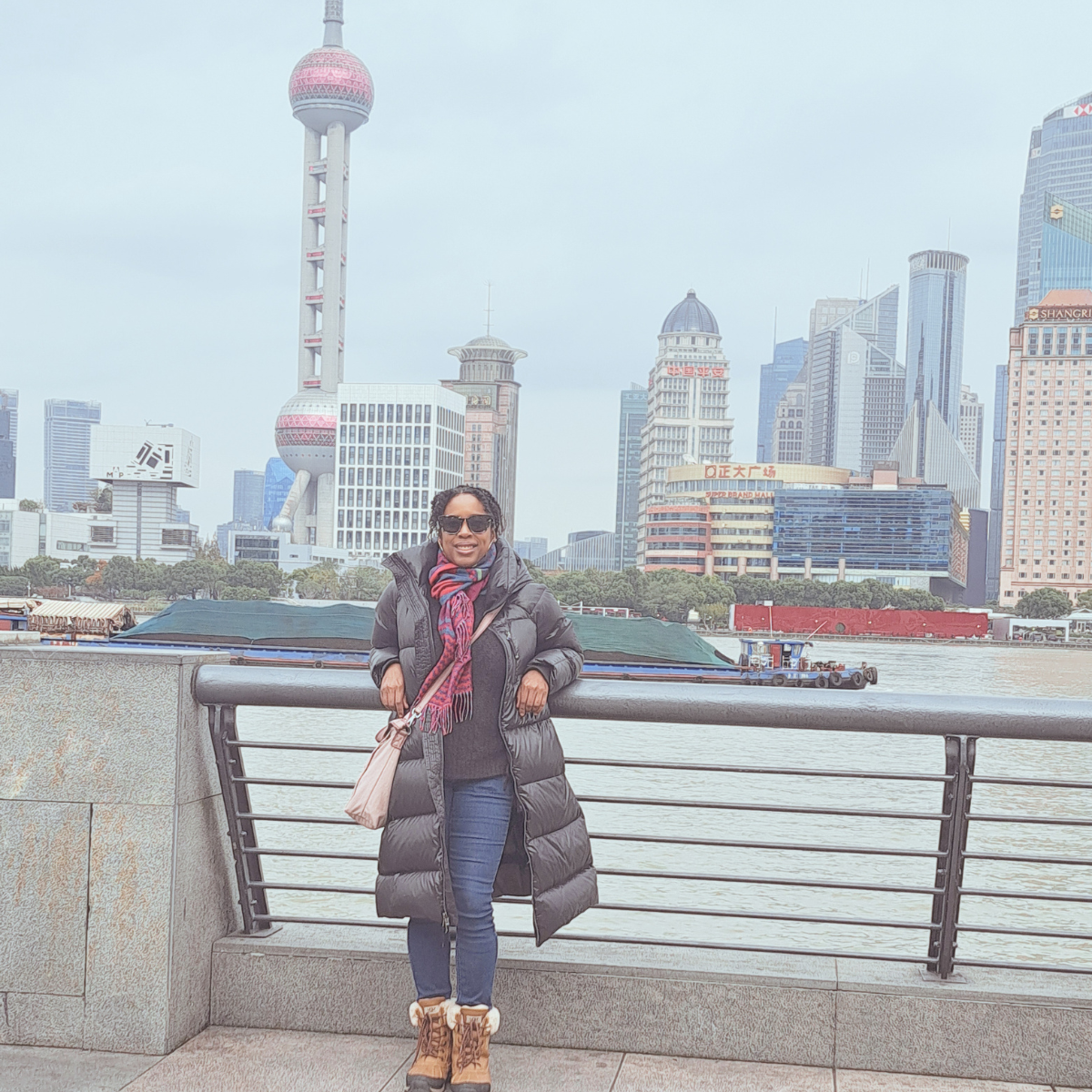 Danielle Brown posing with the Shanghai Bund in the background..