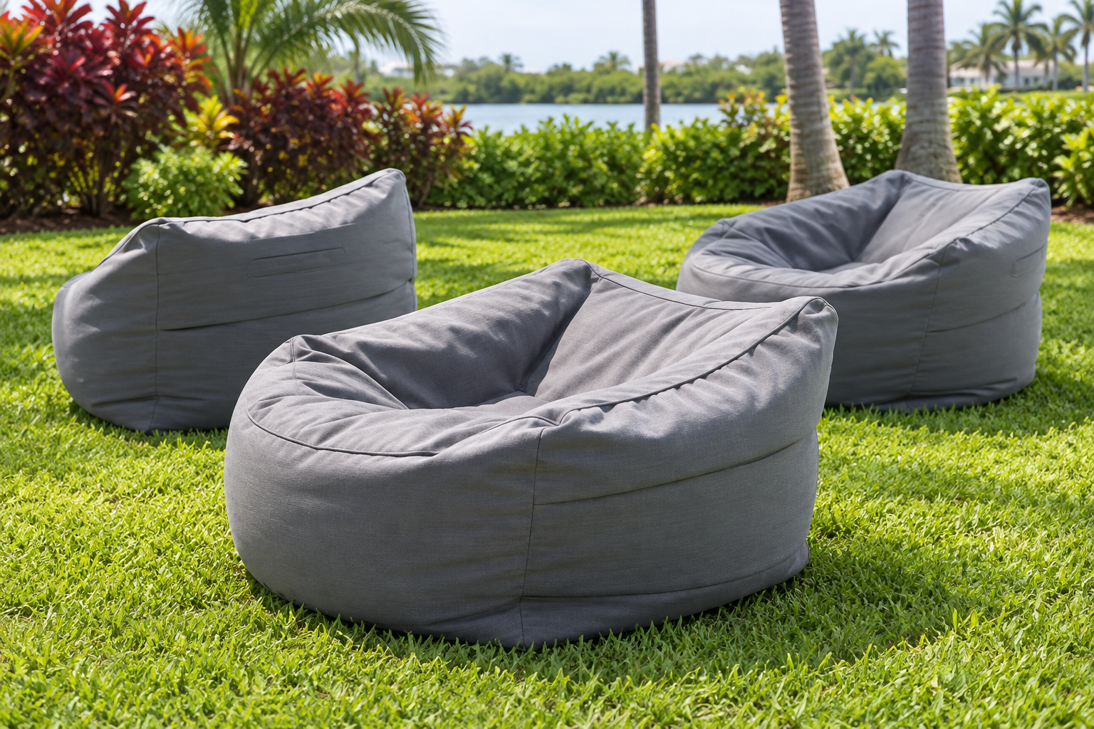 Gray round lounge-style beanbag chairs with a scooped seat and soft fabric sides on a lawn.