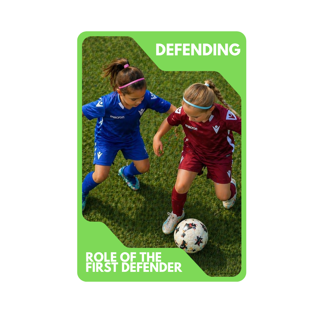 Two young girls playing soccer on the grass, one in a blue uniform and the other in a maroon uniform, competing for the ball.