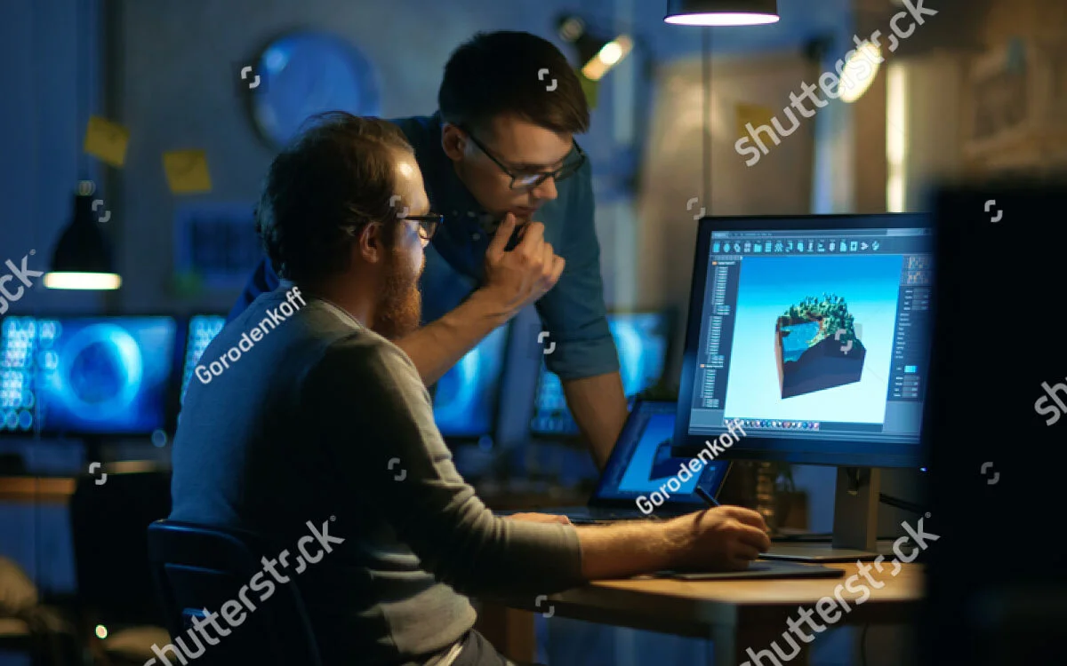 stock-photo-two-male-game-developers-discuss-game-level-drawing-one-uses-graphic-tablet-they-work-late-at-718743145.jpg