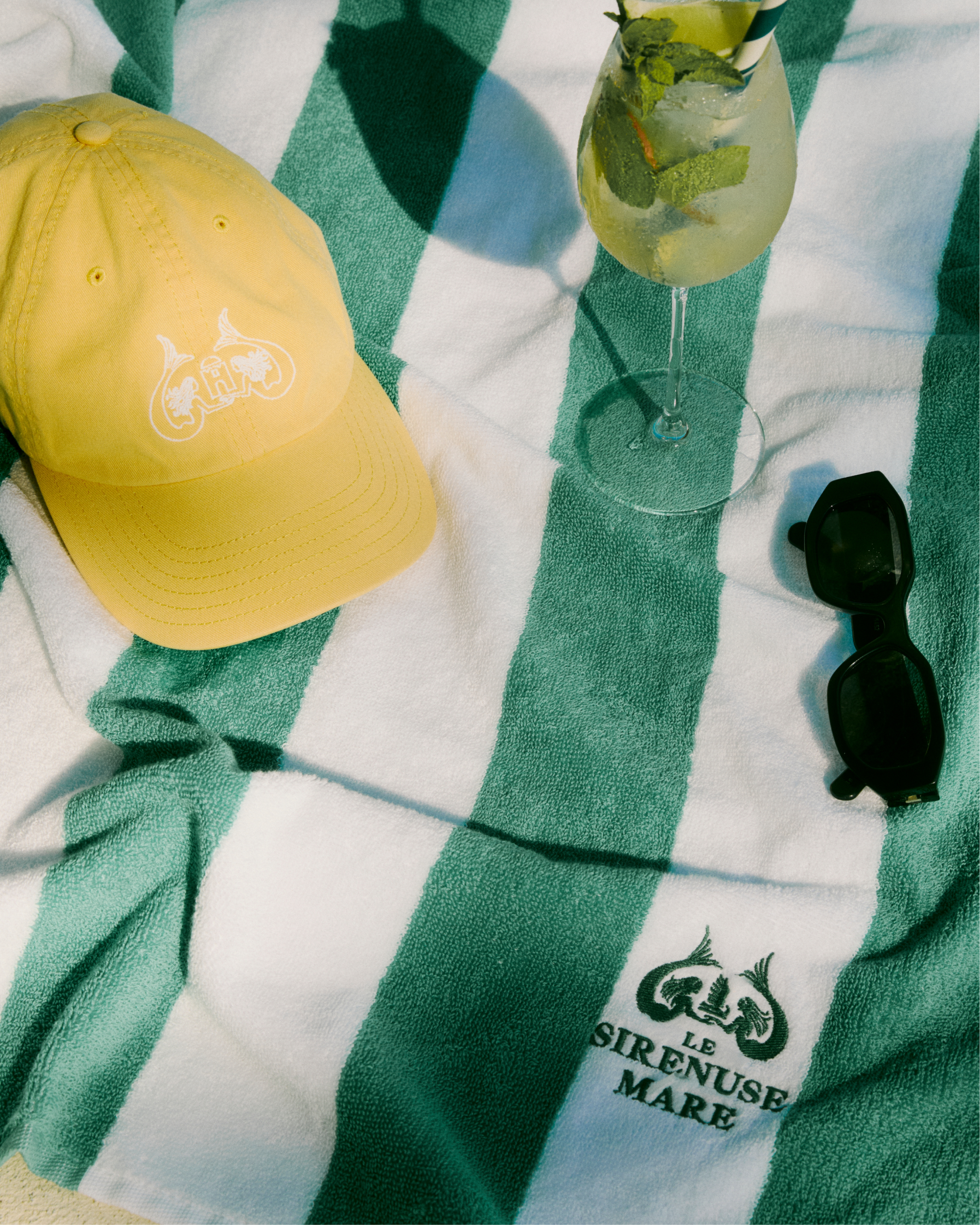 Mucca Le Sirenuse Mare Beach Towel and yellow Hat.png