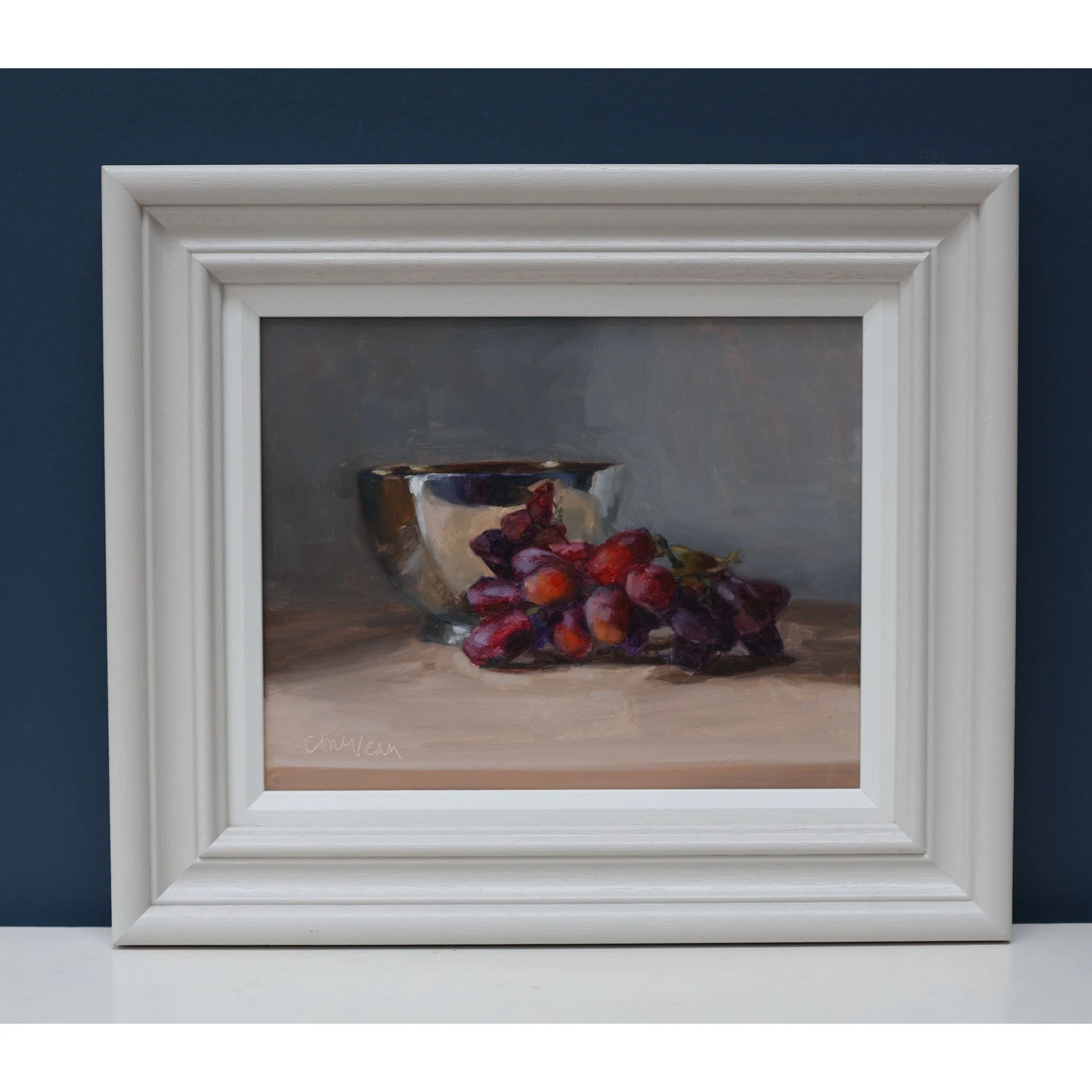 Framed painting of a gold and silver bowl with grapes