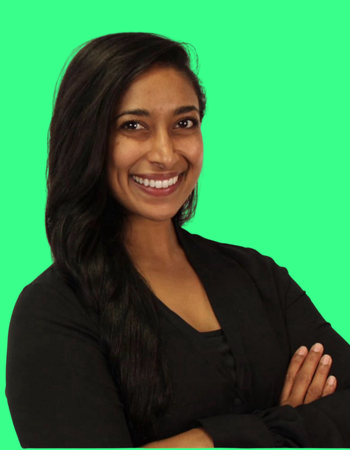 Smiling woman with long dark hair, wearing a black top, with arms crossed, against a green screen background.