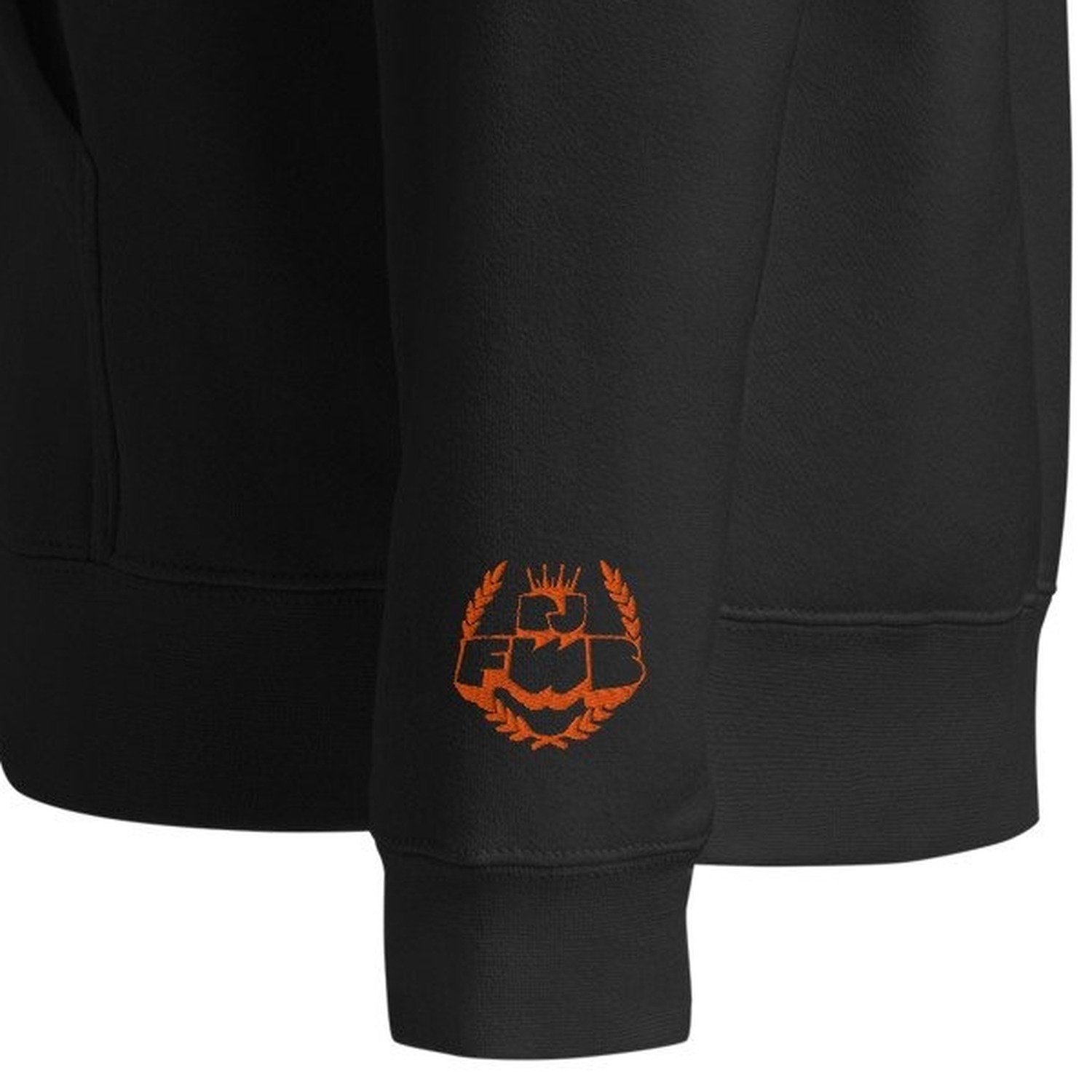 Close-up of the orange DJ FWB crest embroidered on the left wrist cuff