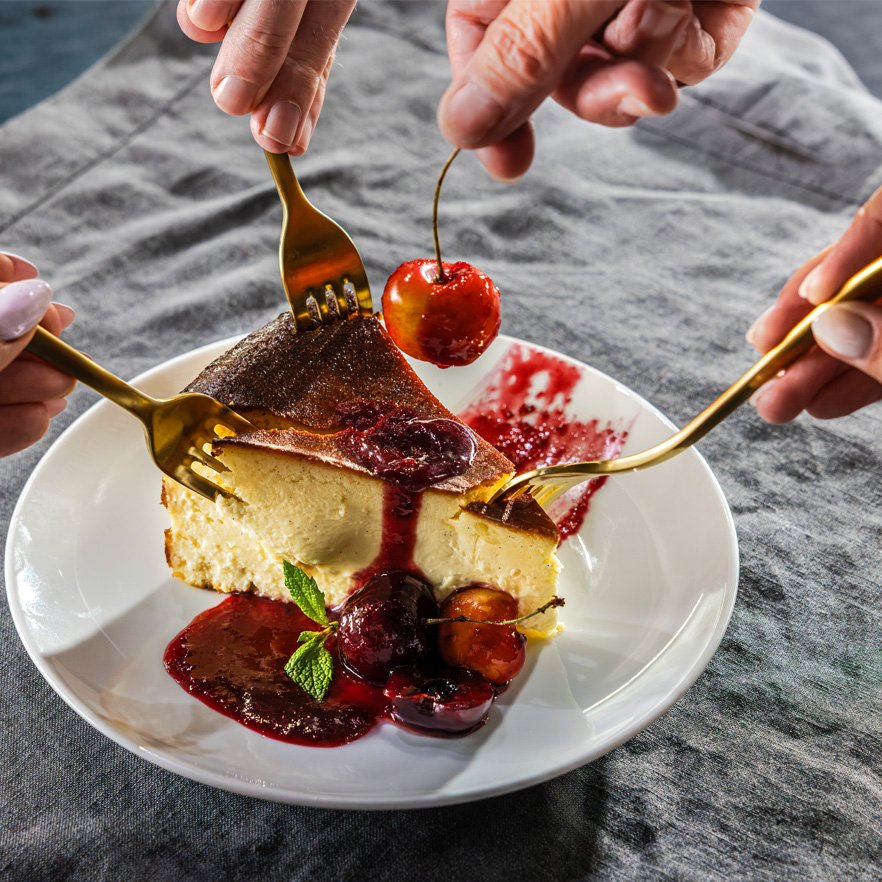 BasqueCheesecakeMulitpleHands.jpg