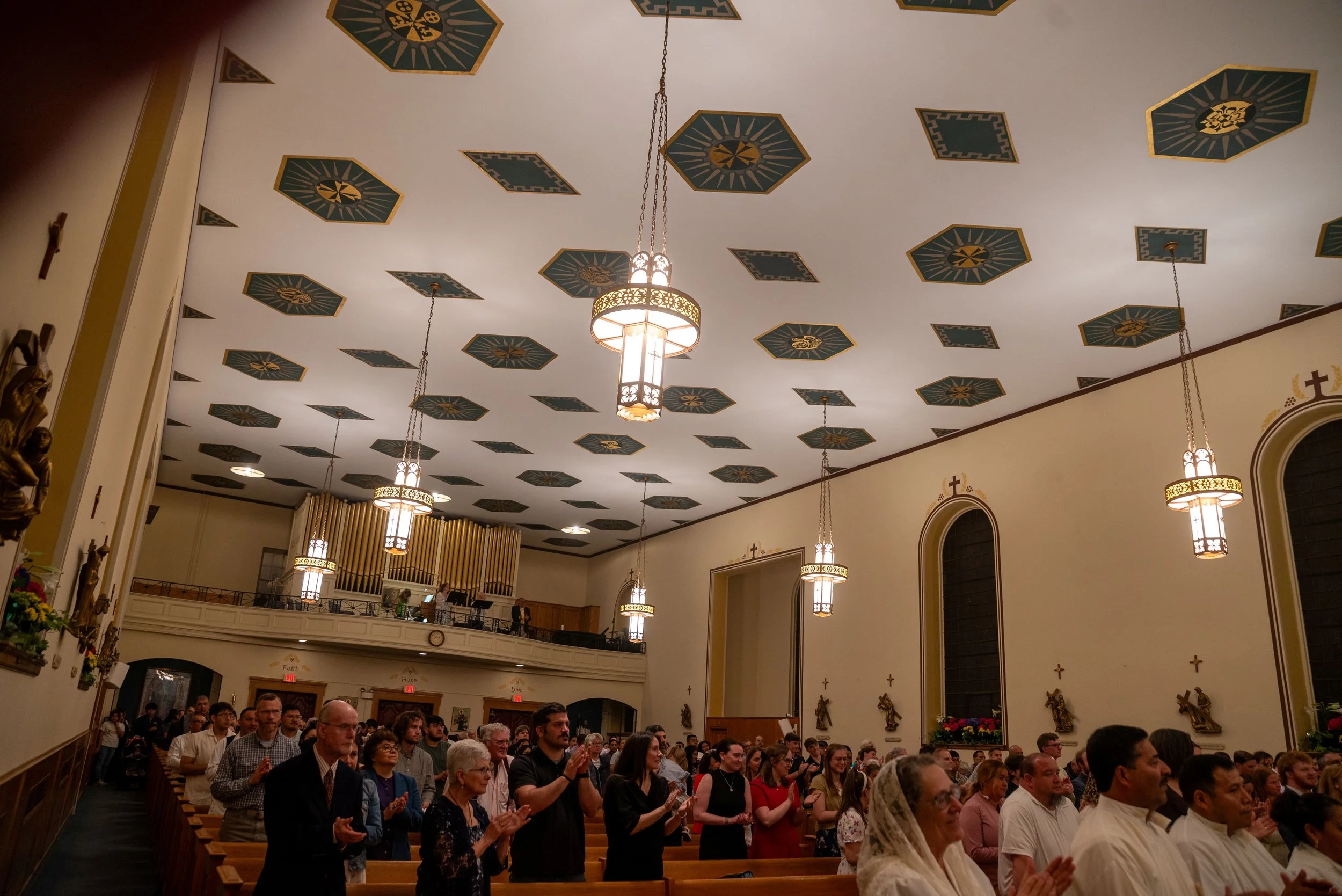 The church congregation applauds and welcomes the new members.
