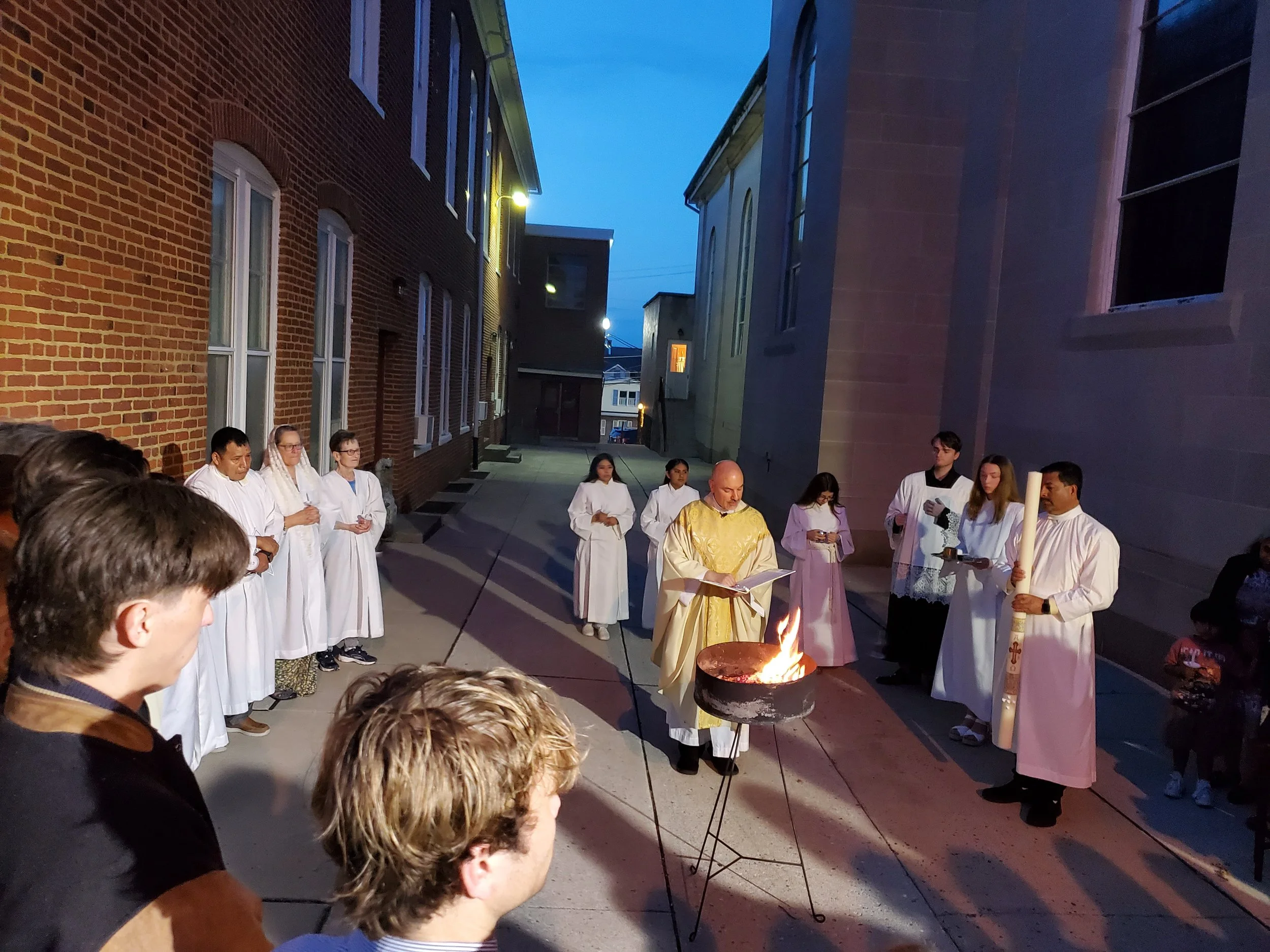 The Easter Vigil begins outdoors at night with a fire. The Paschal candle is lit from the fire, to symbolize Christ overcoming sin and death and becoming the light of the world, so that all who believe in him might have eternal life.