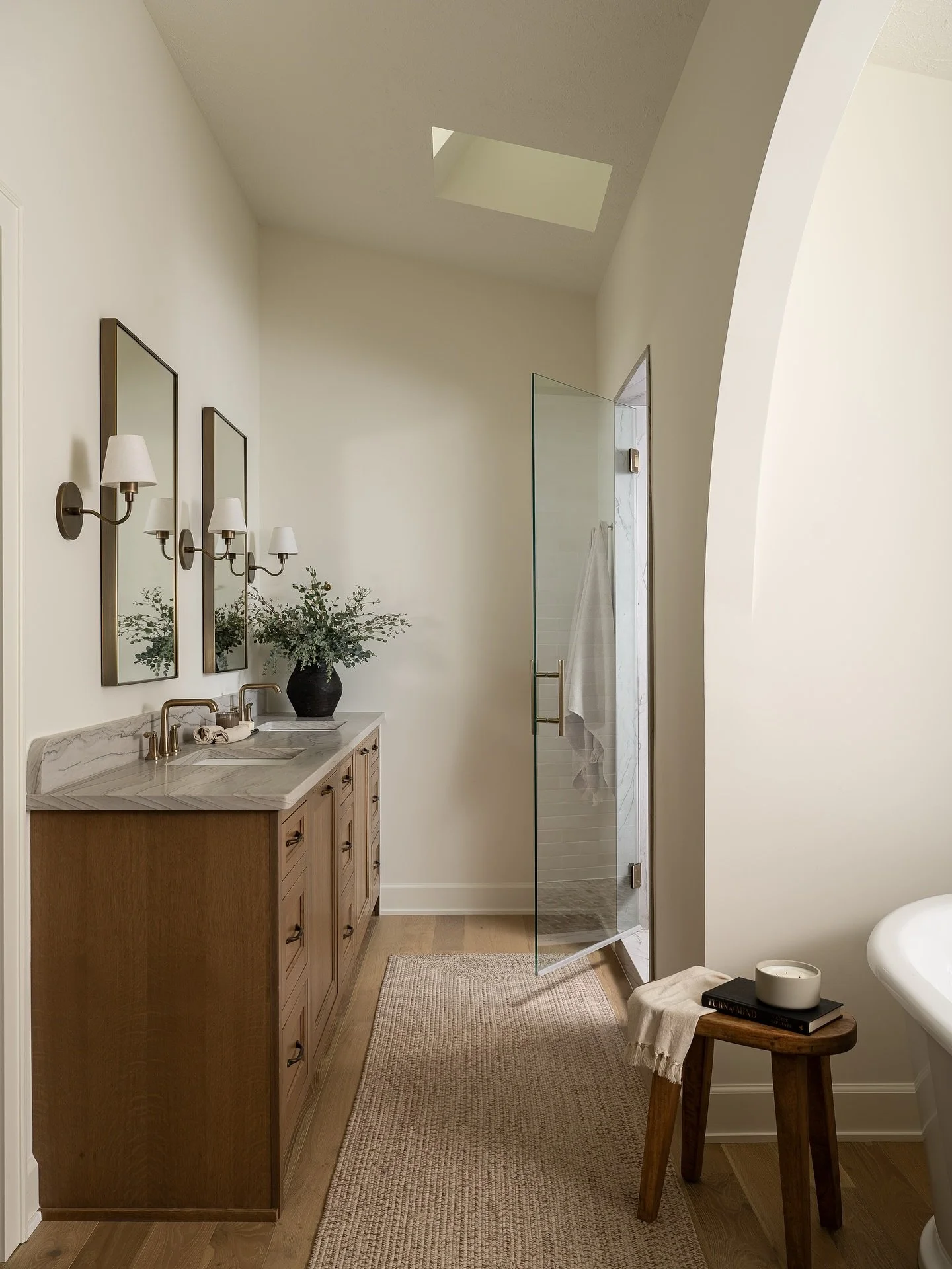 Natural light where you least expect it! This bathroom gets a bright, airy feel thanks to a ceiling window — perfect for a windowless space.
Photo by @sarahshieldsphoto 
#aaNovo #CustomHomes #BathroomDesign #Light #Windows #Plants #InteriorDe
