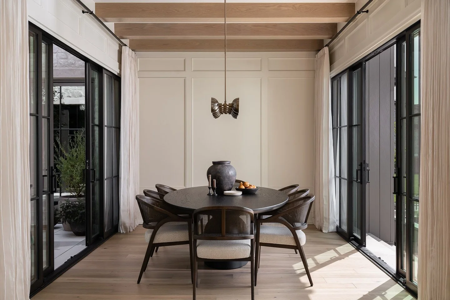 Spot the difference? This dining room holds a subtle surprise &mdash; a hidden door designed to disappear seamlessly into the wall. It&rsquo;s details like this that elevate both the beauty and function of a space.

During the day, the open doorway a