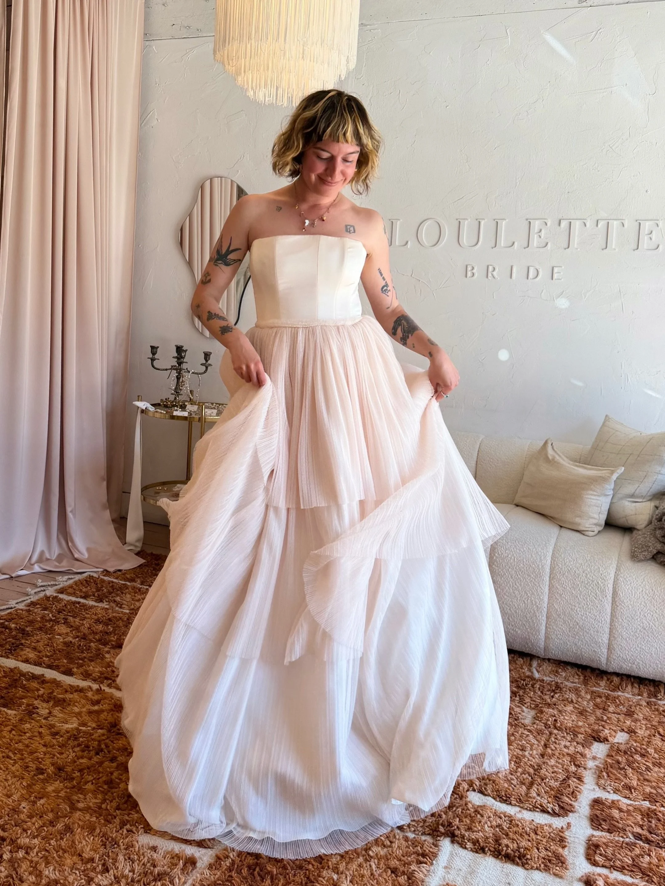 ✨EMMA✨ Emma is a sweet confection of blush pleated tulle, a silk satin charmeuse bodice, and adorable ruffle details that make her as sweet as can be! With a structured strapless bodice, tiered pleated tulle skirt, and extra layer of crinoline for ad