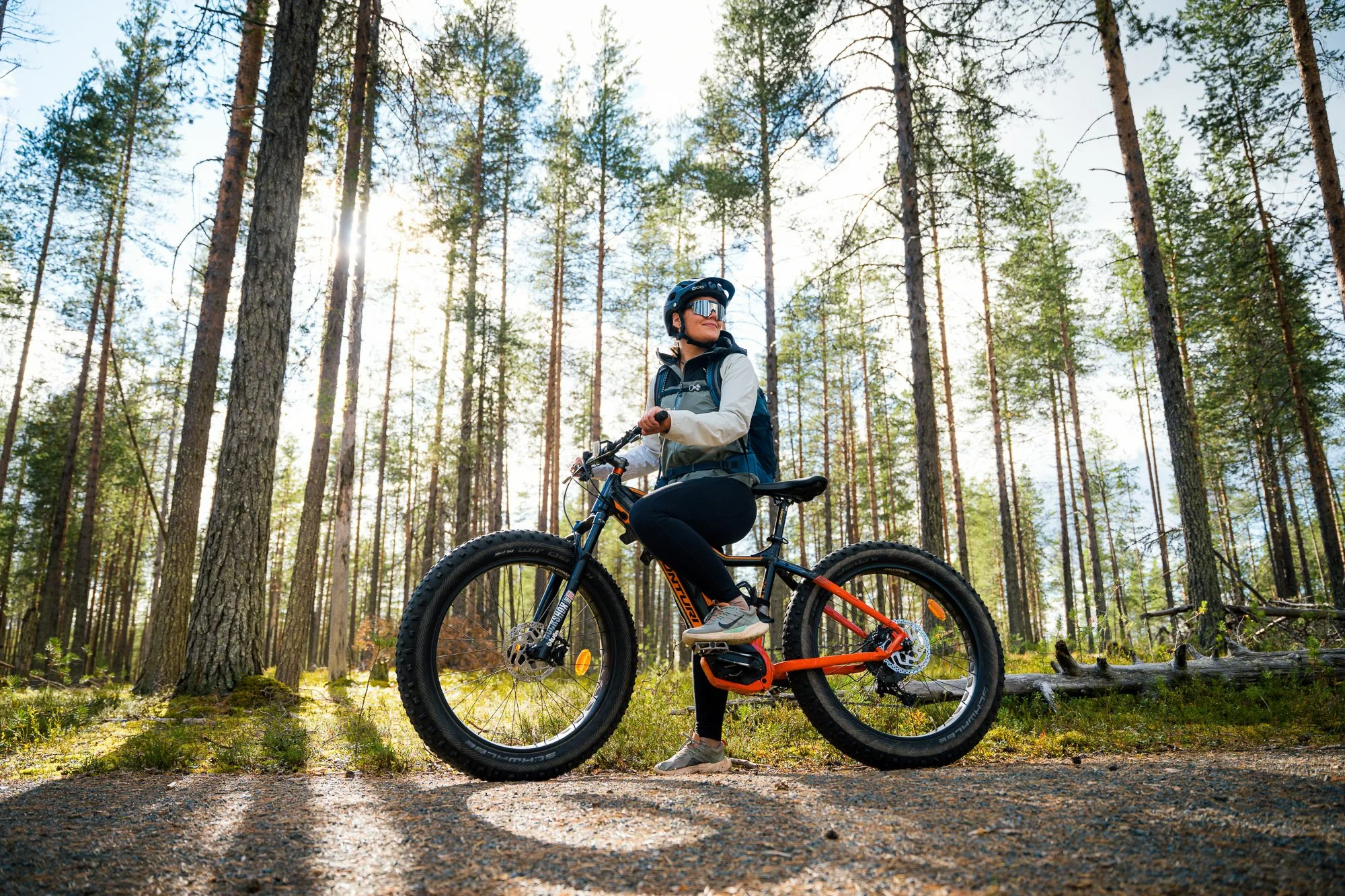 Suomussalmi-finland-kainuu-summer-kesä-biking adventure-bicycle-polkupyörä-fatbike-woman smiling-sunshine through thee trees-hossan kansallispuisto-national park©Filved Agency.jpg