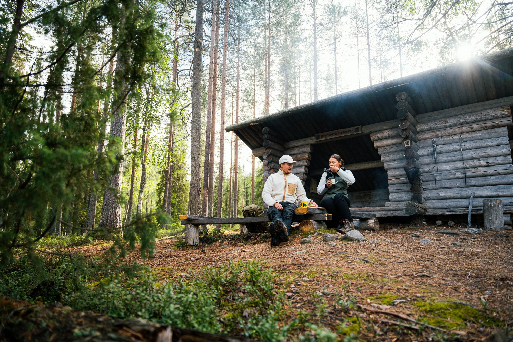 Suomussalmi-finland-kainuu-summer-kesä-hossan kansallispuisto-camping-hut-fire pit-sunshine-laavu-national park-man and woman smiling-european man.jpg