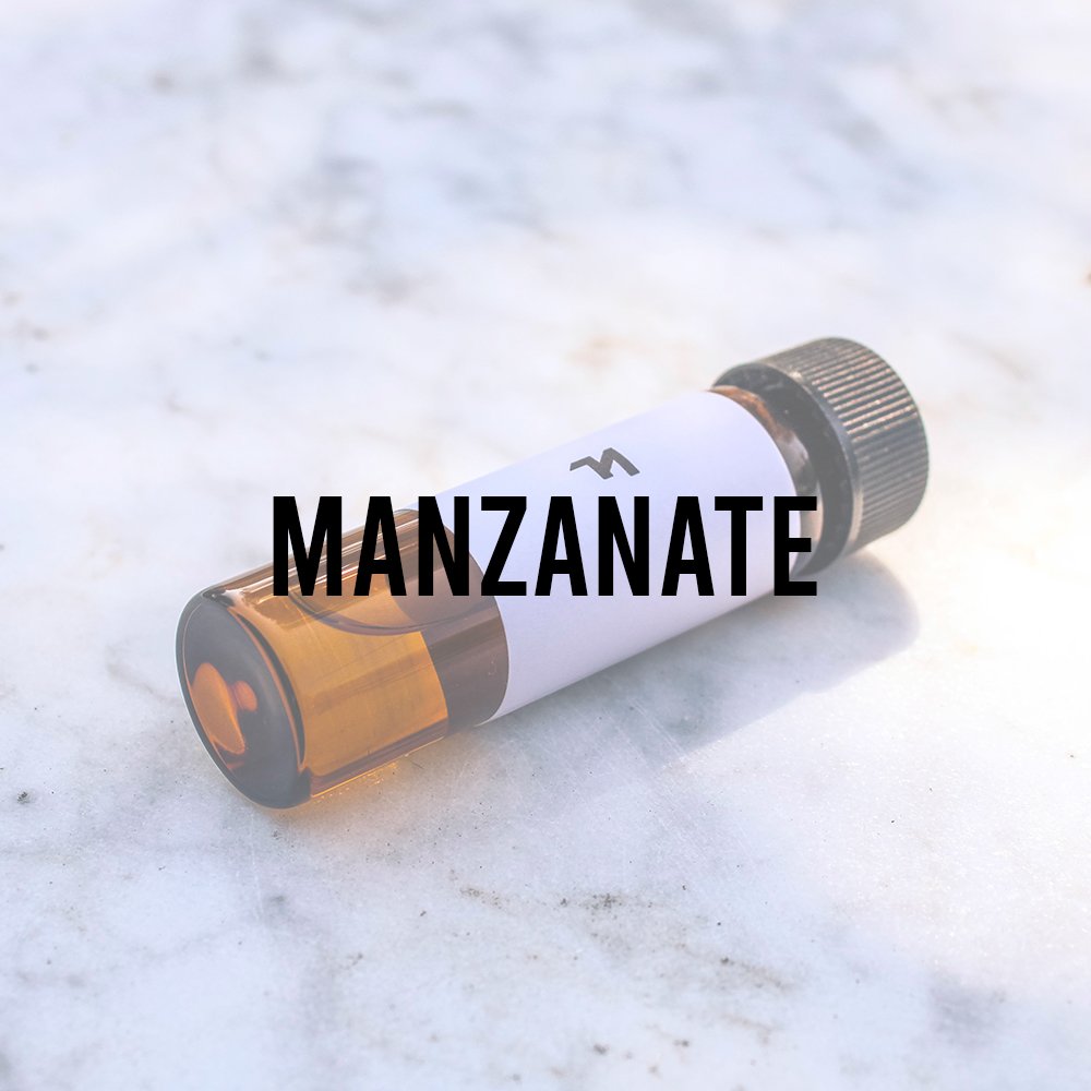 manzanate vial on marble background chemical synthetic ingredient perfumery scentspiracy