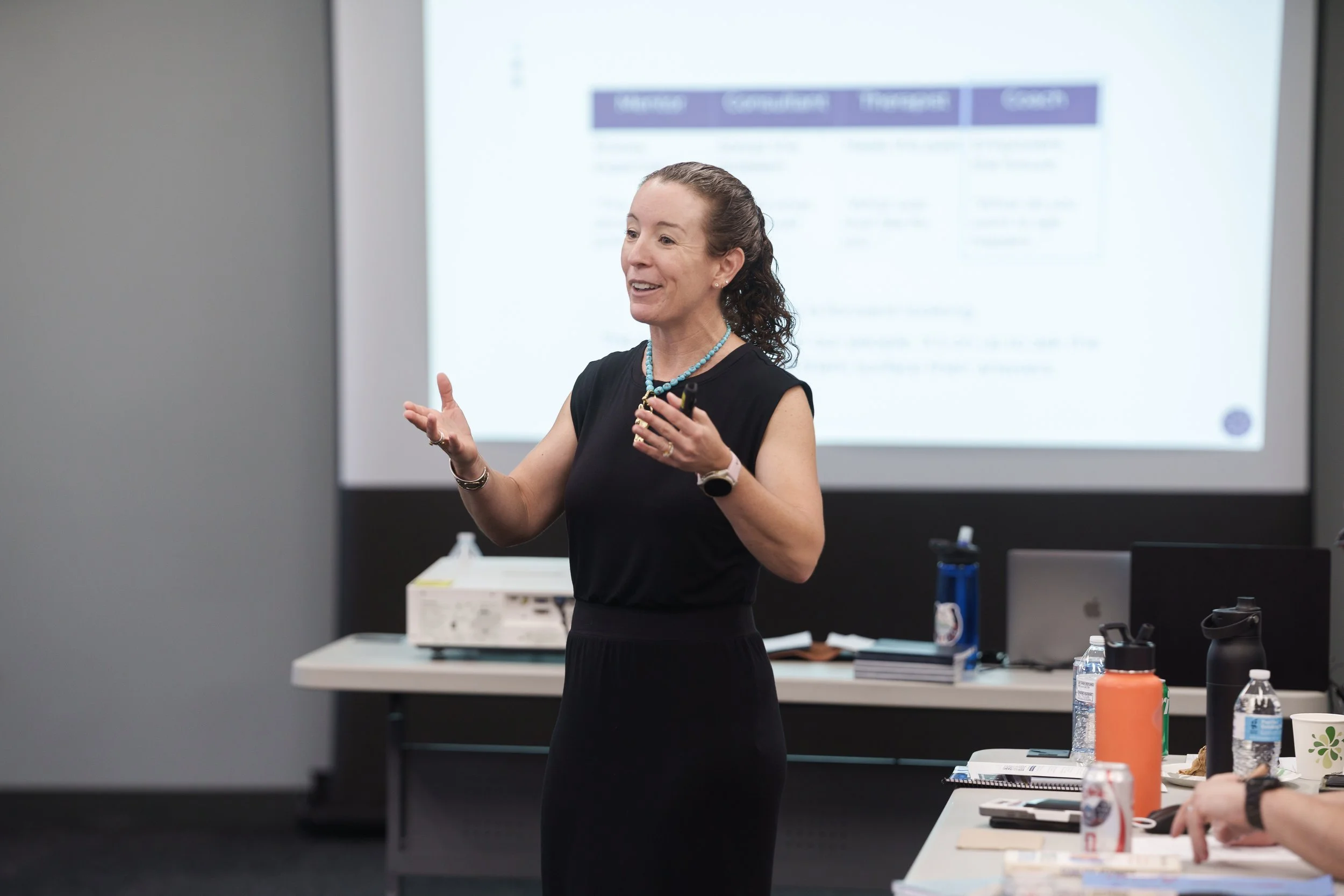 This is an image of Katie O'Brien Ceccarini, award-winning author of Fearless Feedback. She is speaking to an audience of managers, teaching a 3 hour workshop on Managers as Coaches.