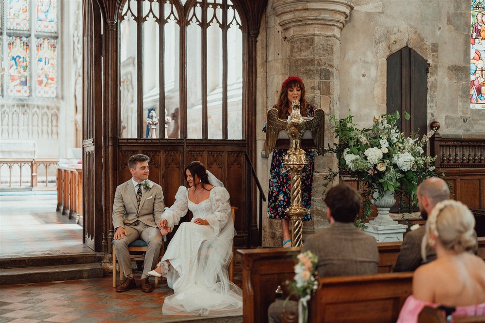 Bride and groom during readings with sustainable floral urn