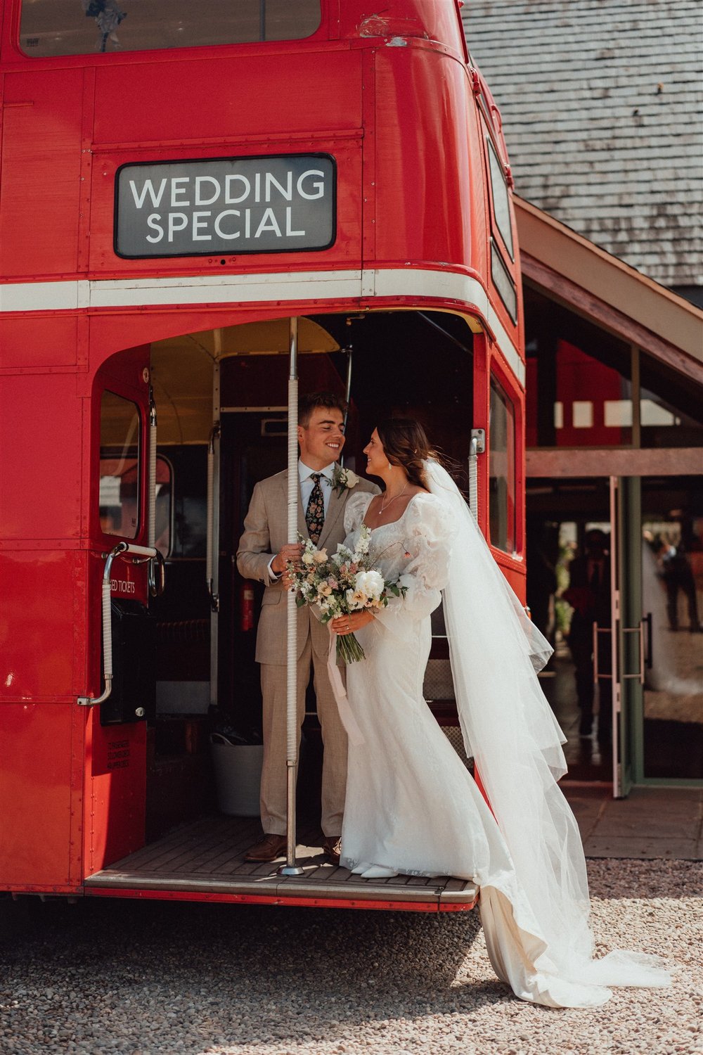 Quintessental English country garden wedding with red london bus to transport guests