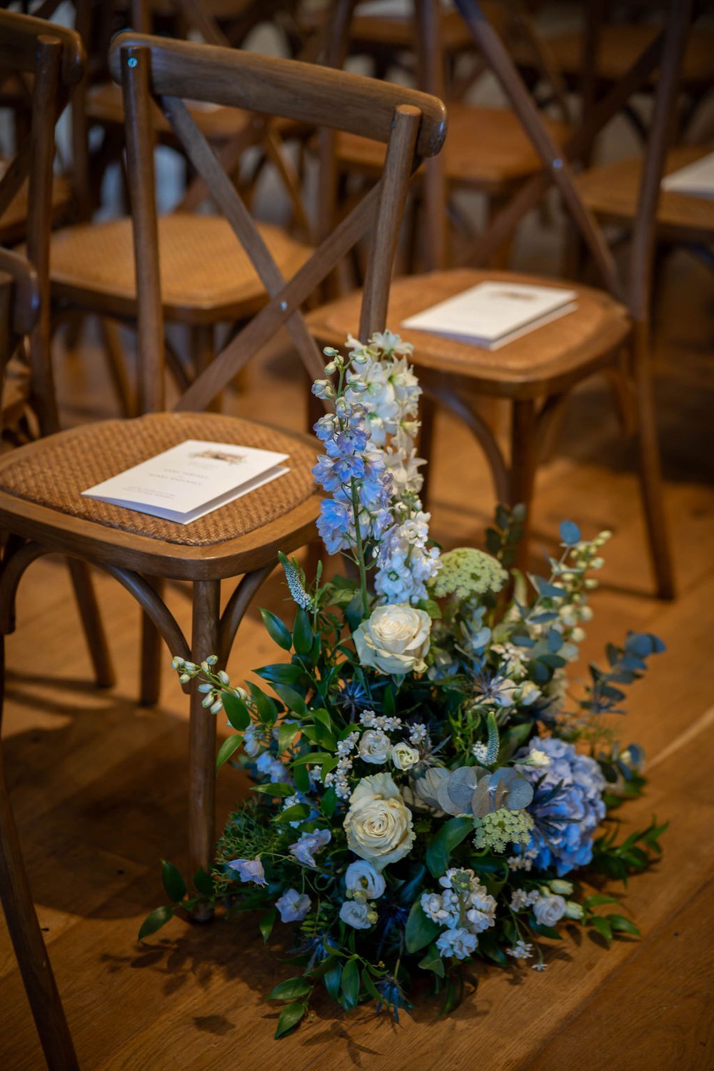 Aisle meadow flower designs in the ceremony room at Primrose Hill Farm