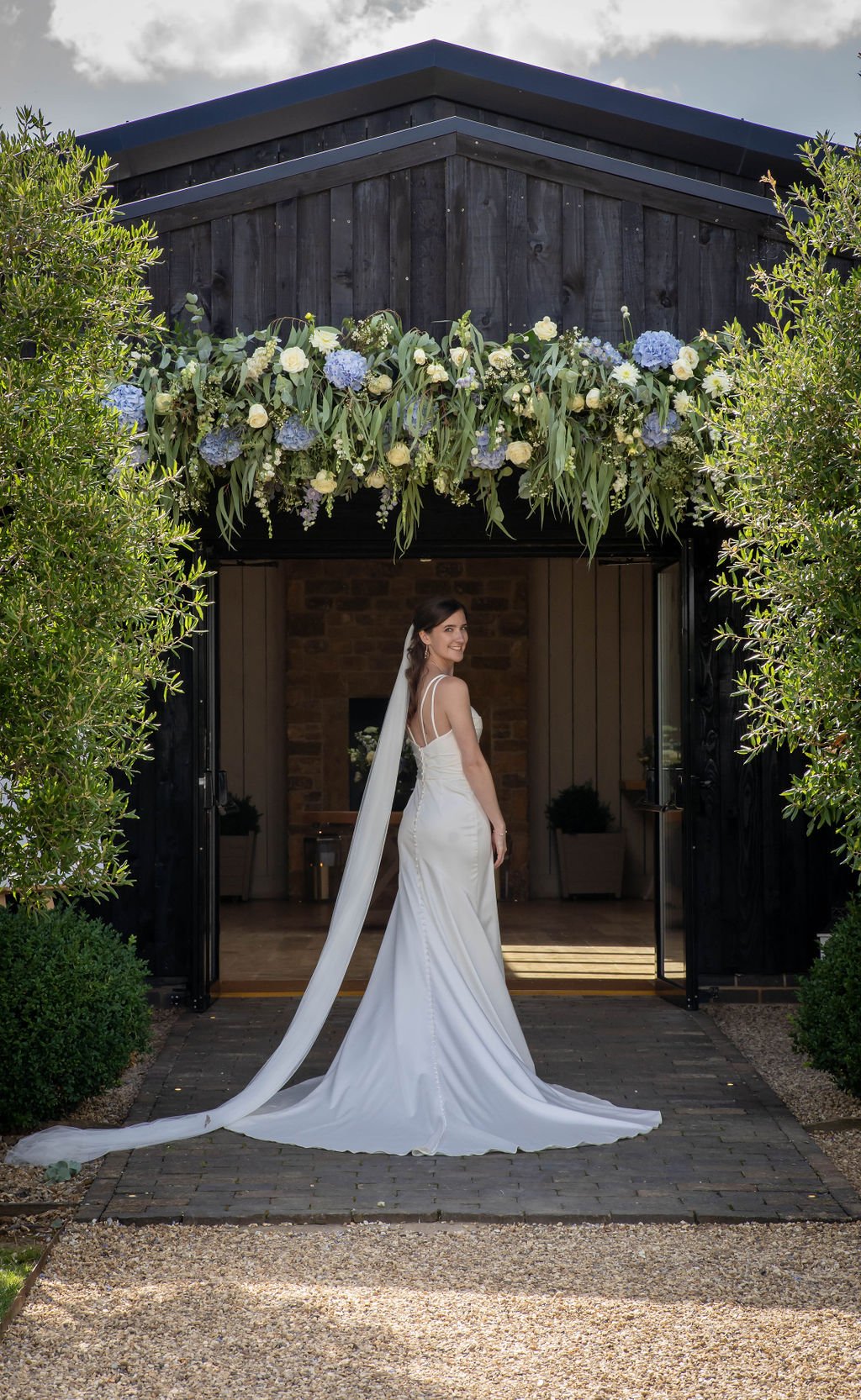 Primrose Hill Farm bride under a floral arch entrance