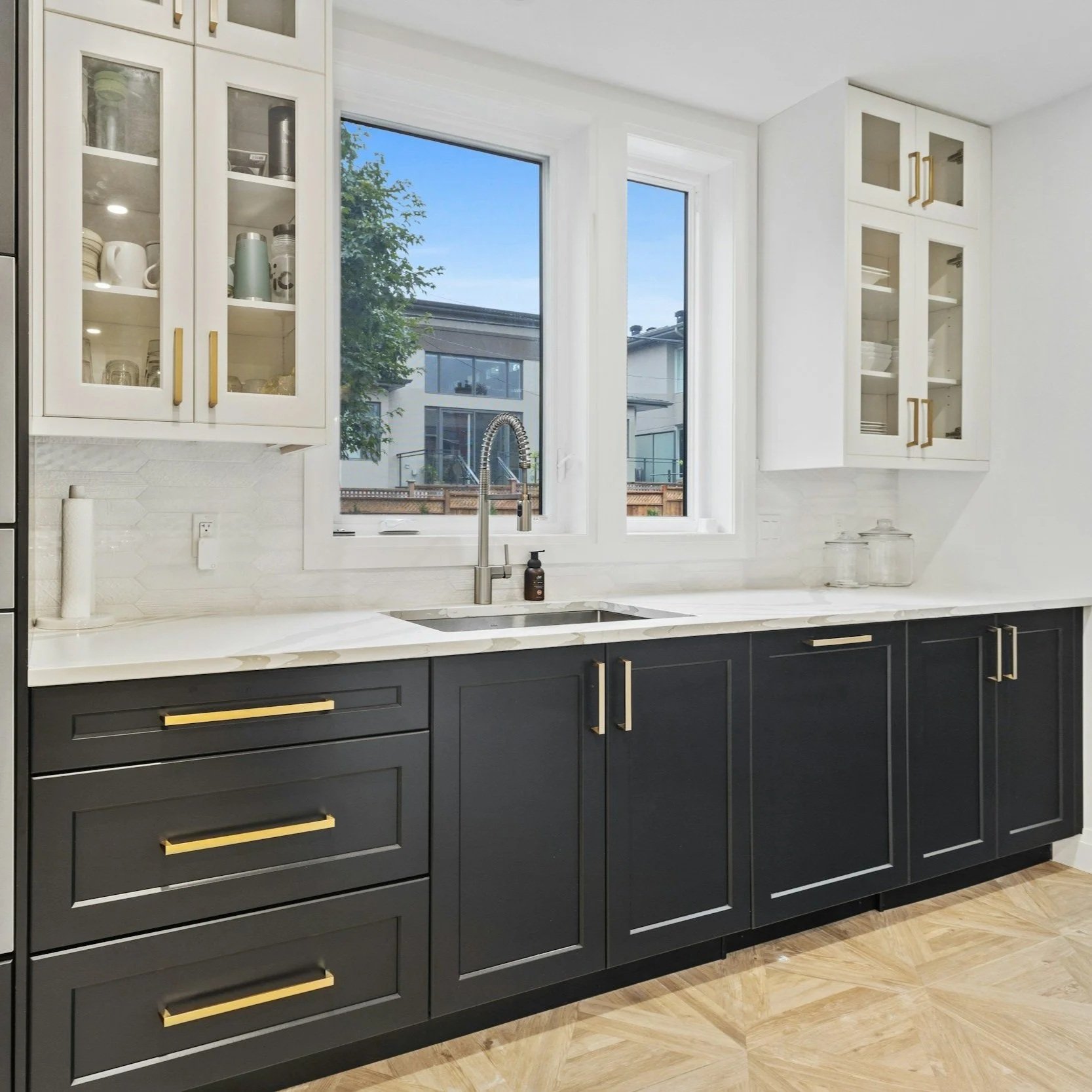 Black and white kitchen cabinets with smooth painted finish, showcasing durable cabinet coatings and modern Tampa kitchen design styles.