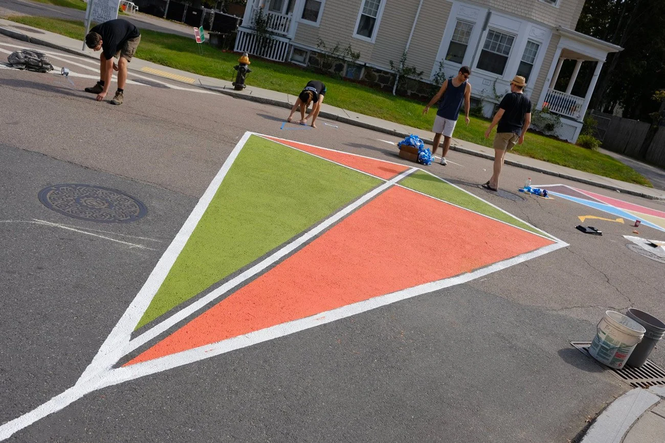 Street mural of a green and orange kite