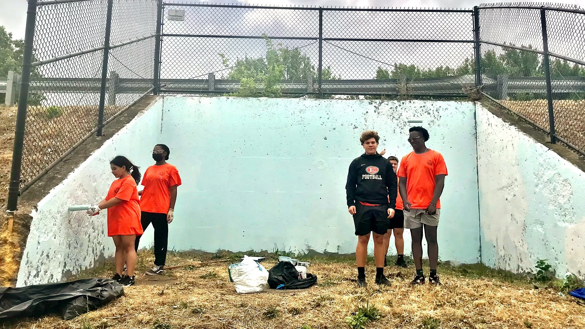 Crew cleaning up mural surface