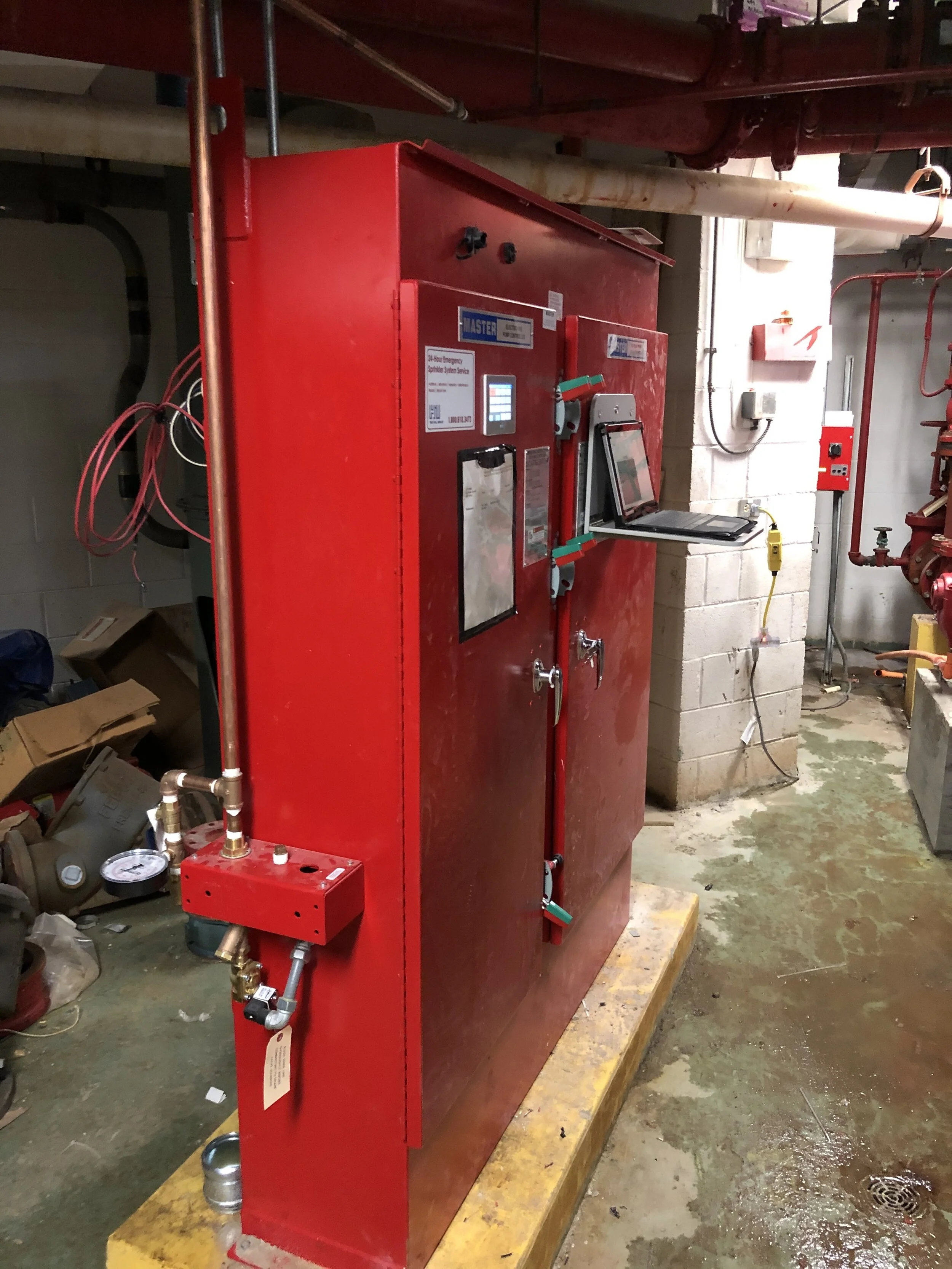 Newly installed fire pump controller in a fire pump room.