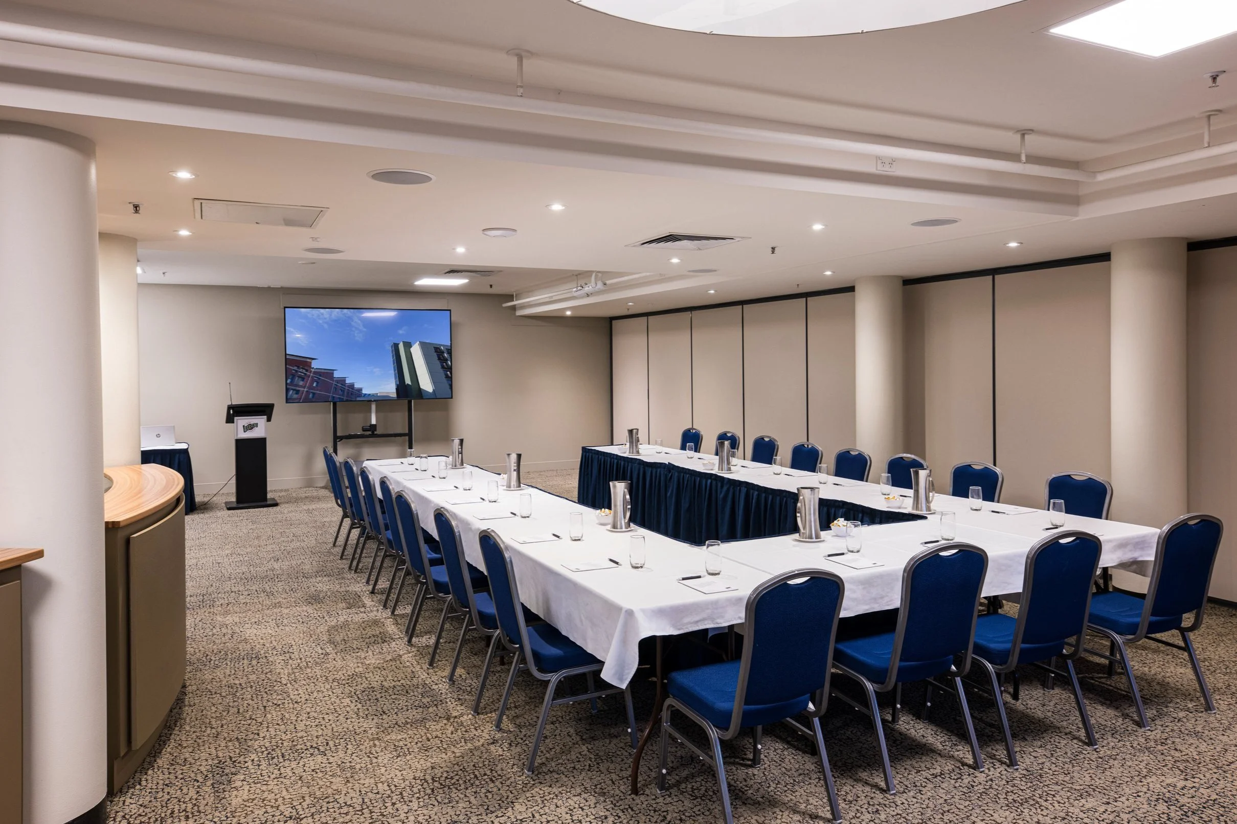 Private multi purpose event room with screen and podium