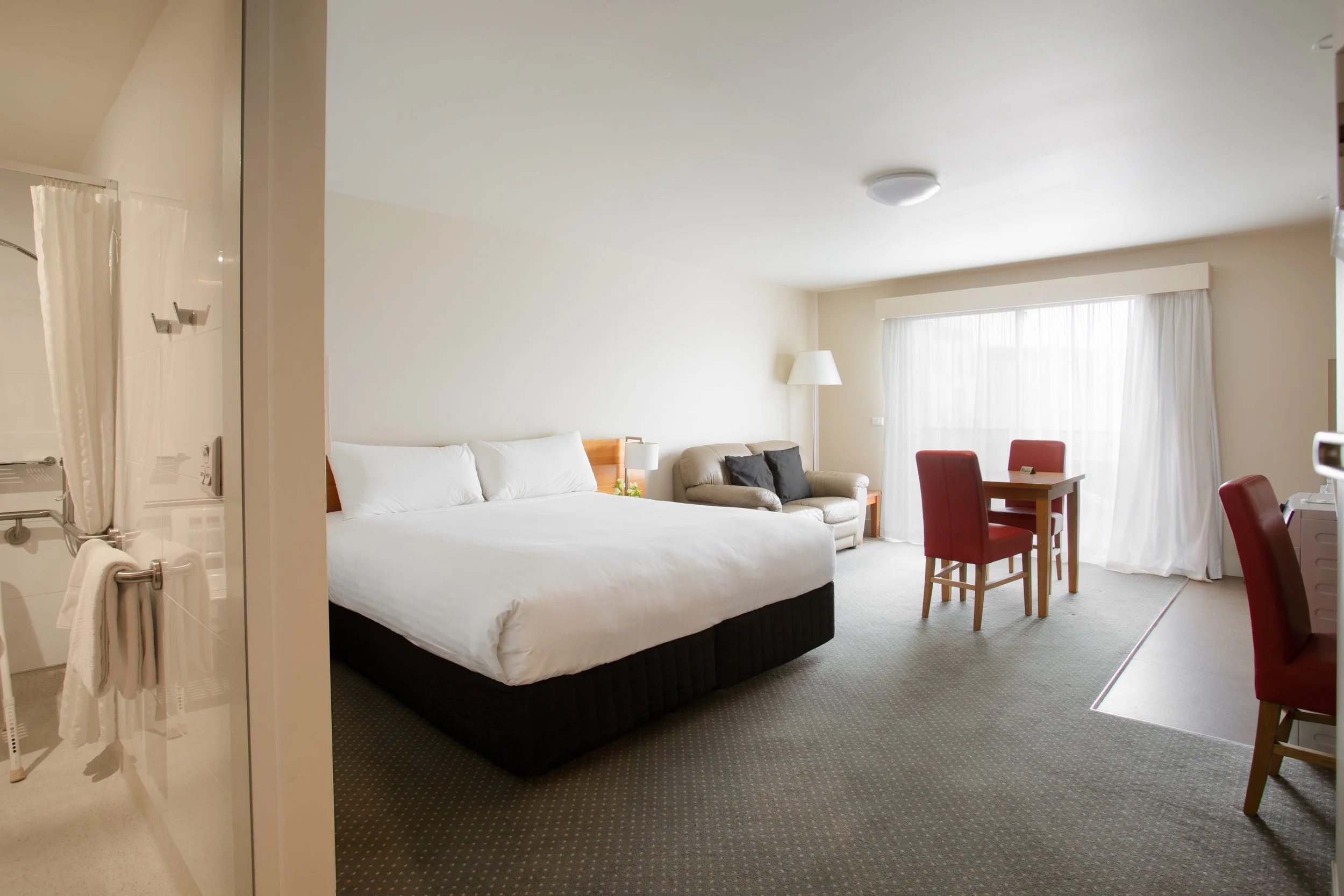 The Old Woolstore accessible apartment with bed, living area and kitchenette