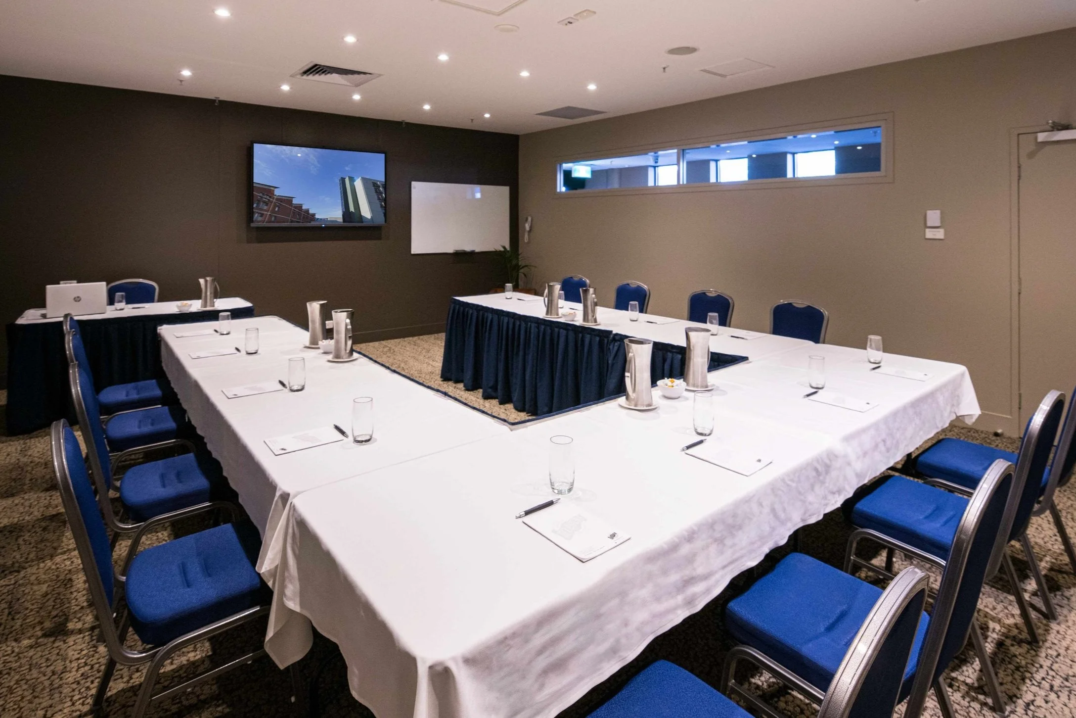 Multi-use event room with screen and U shape table