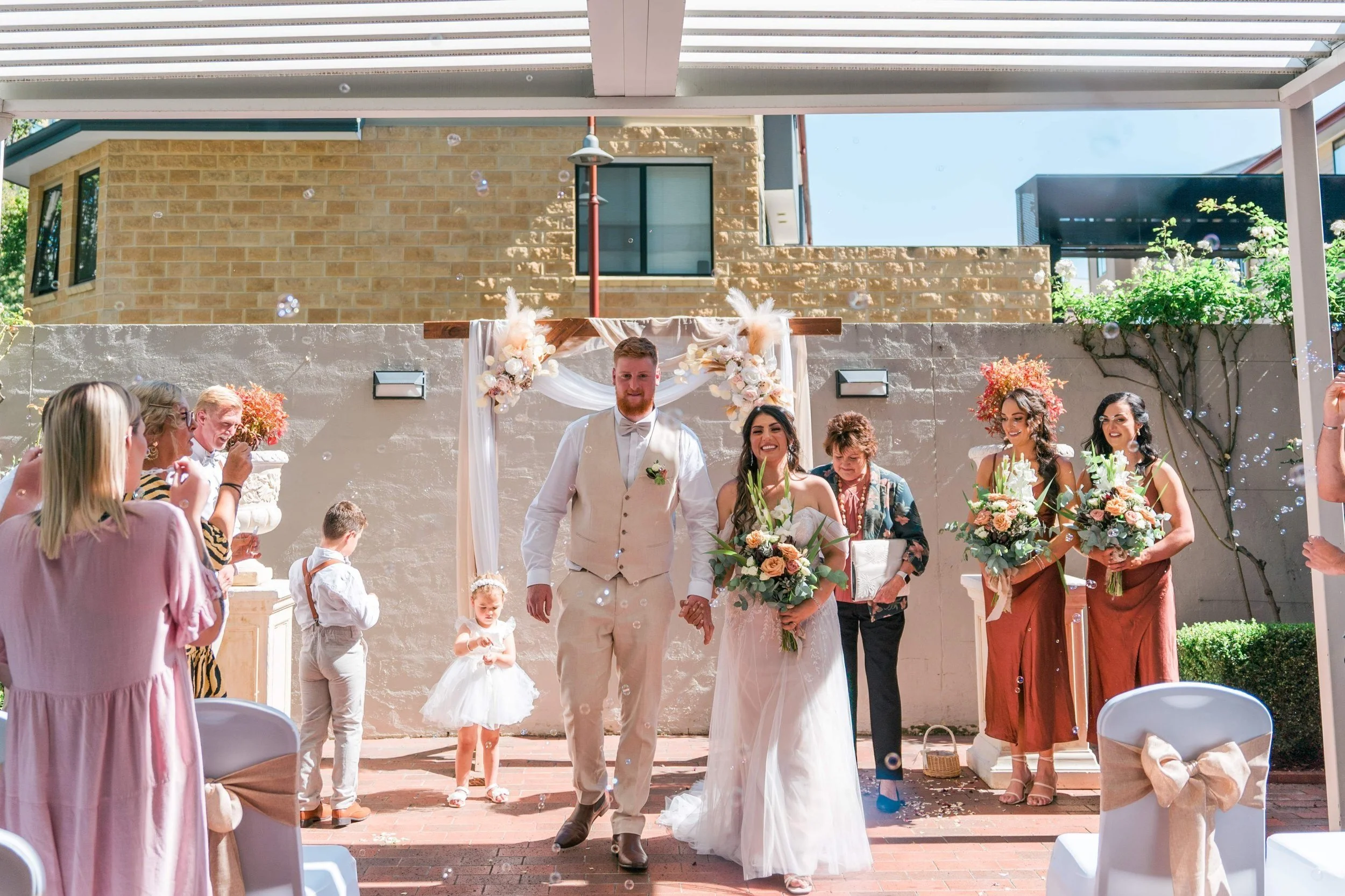 Outdoor wedding ceremony in the Rose Garden at The Old Woolstore