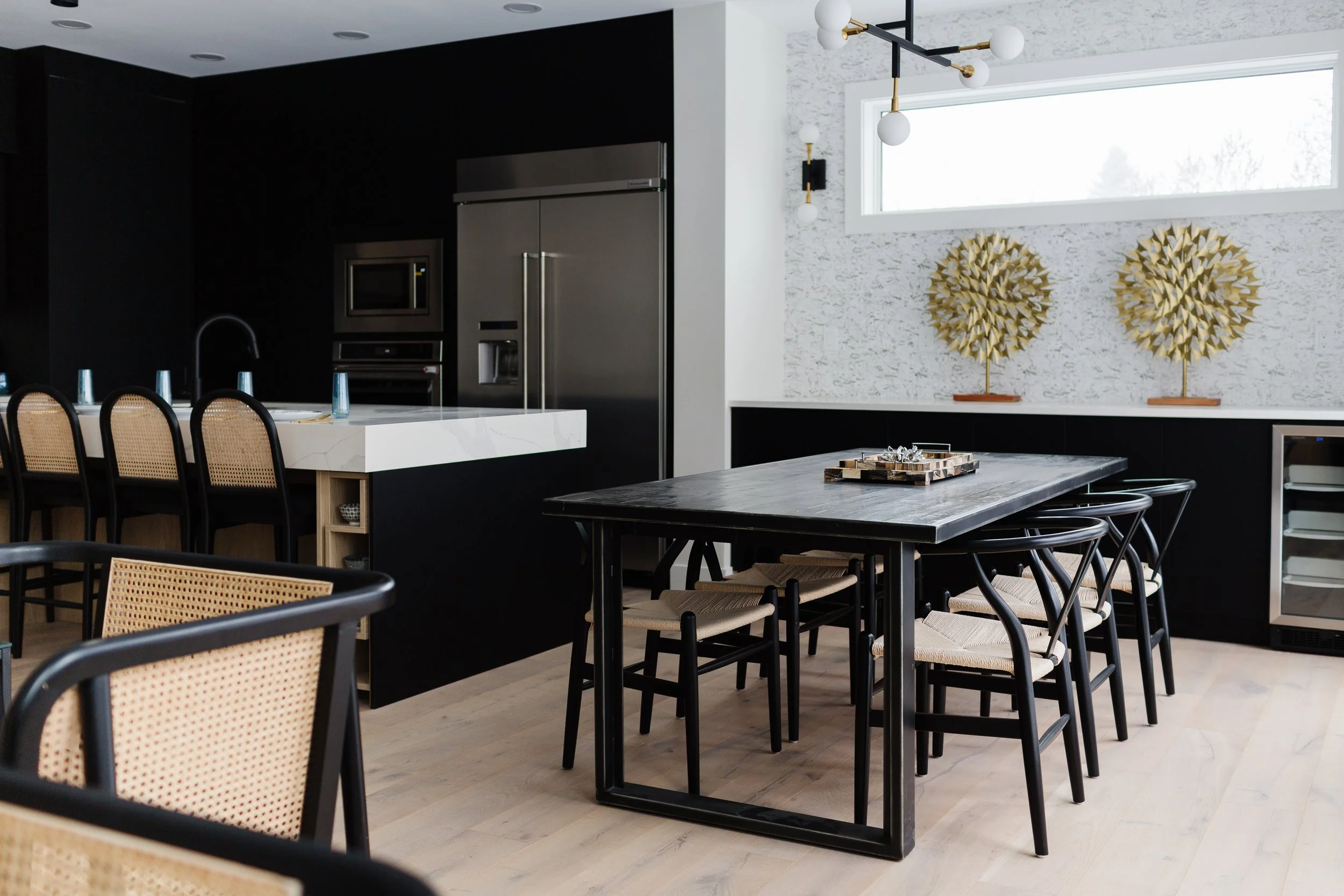 Photo of a dining room with a black table with a tray on top surrounded by black bamboo chairs