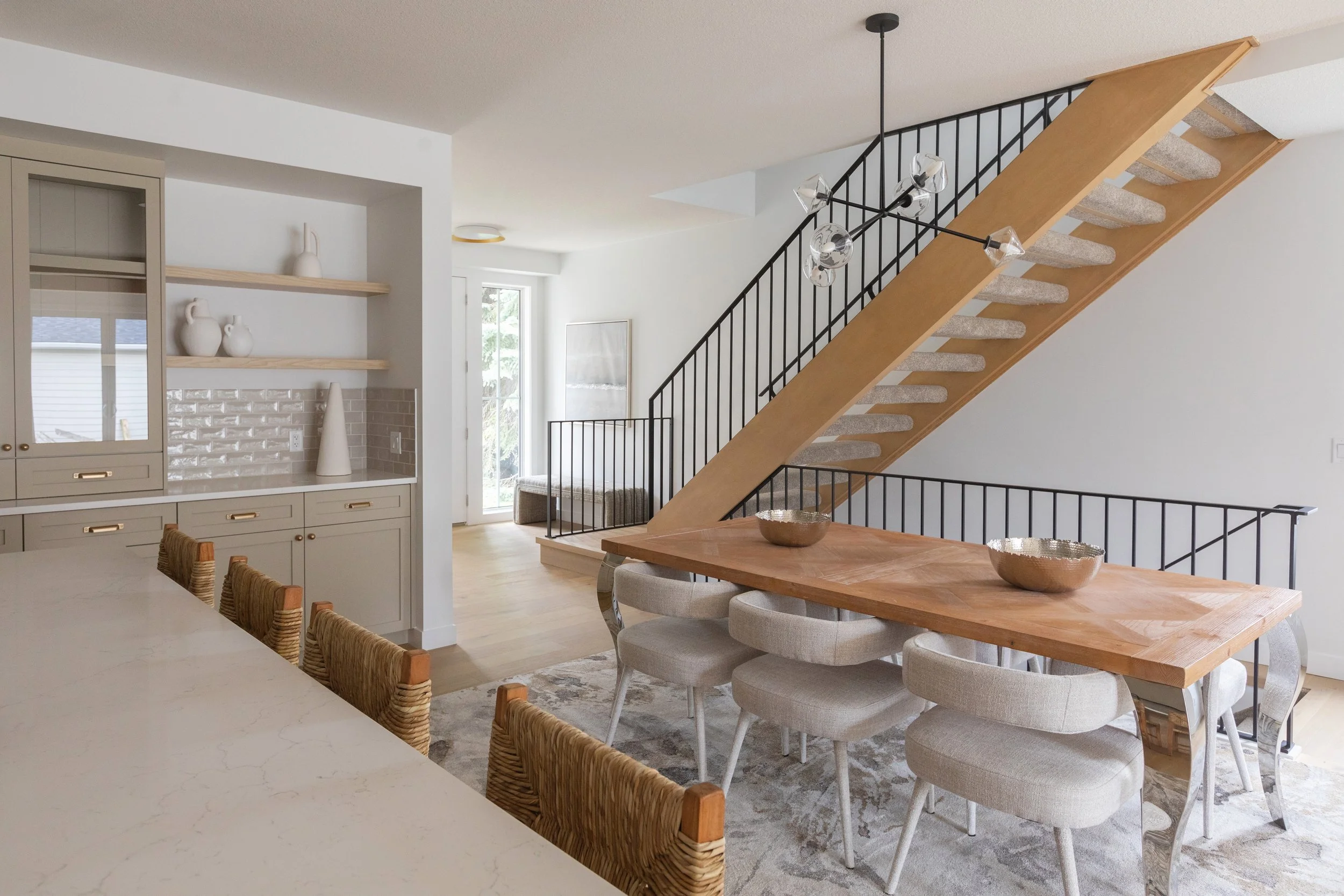Photo of an open-concept dining and kitchen area with wood furniture and beige accents