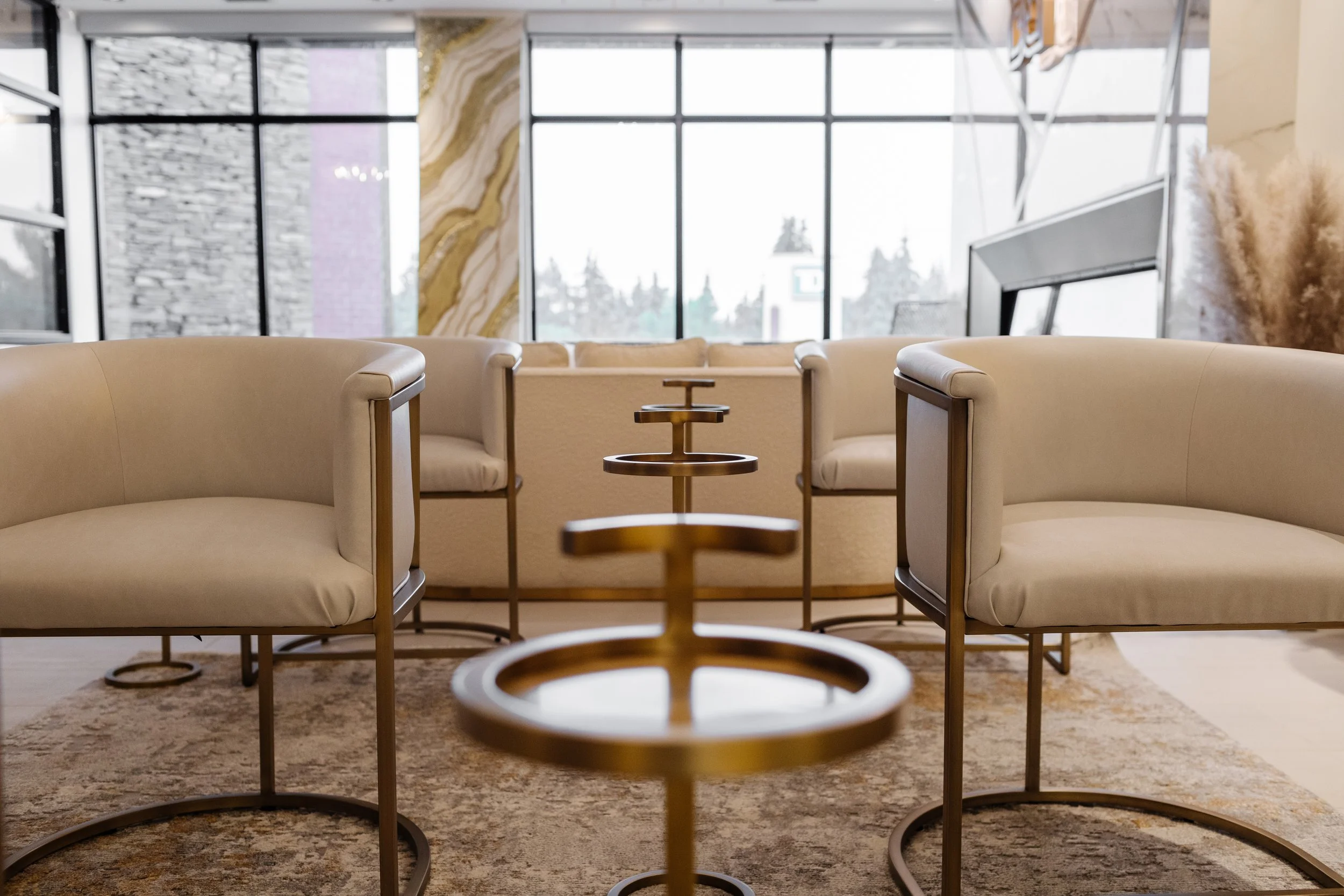 Photo of a row of gold tables in between rows of white chairs