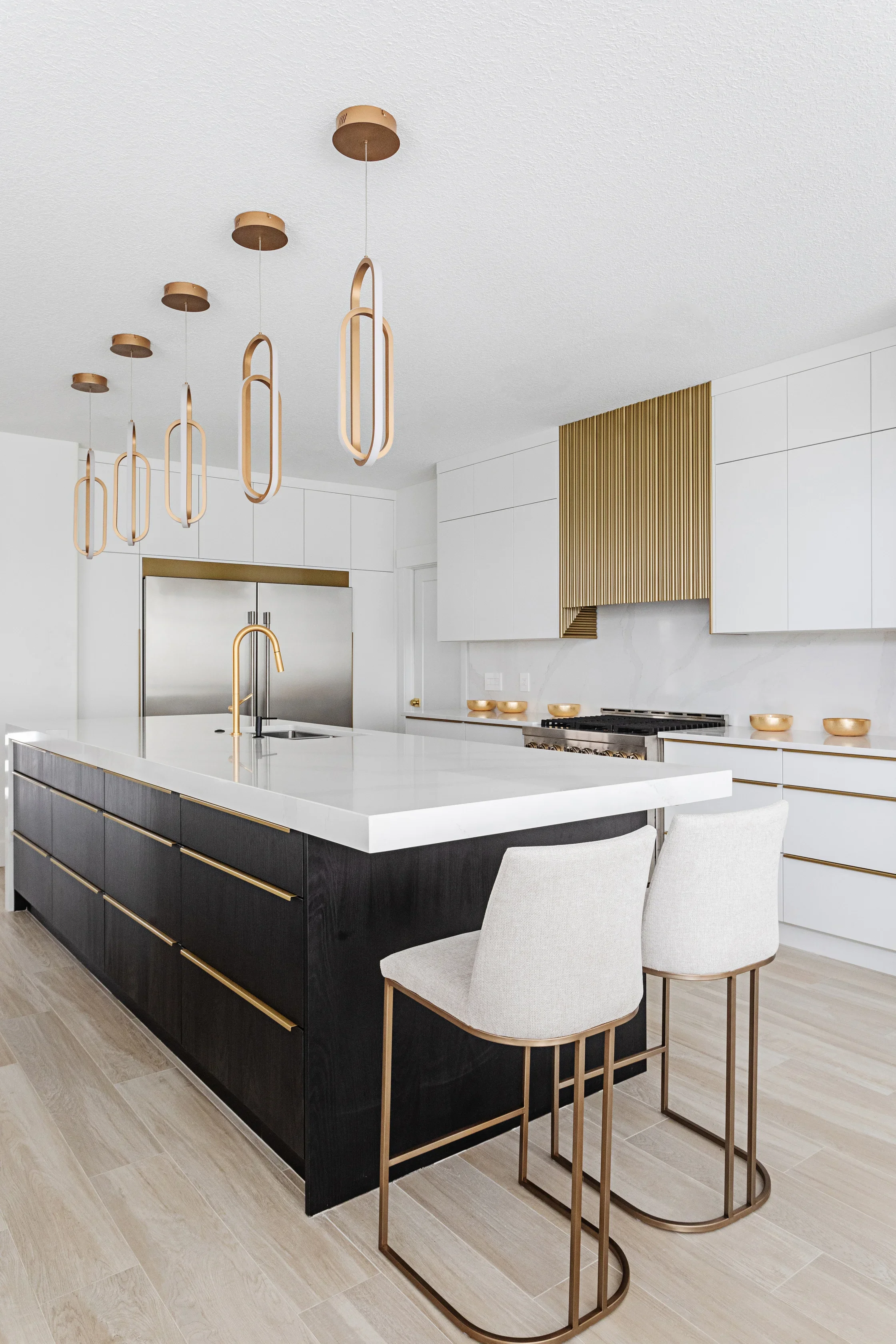 photo of a modern white kitchen with gold and brass decor