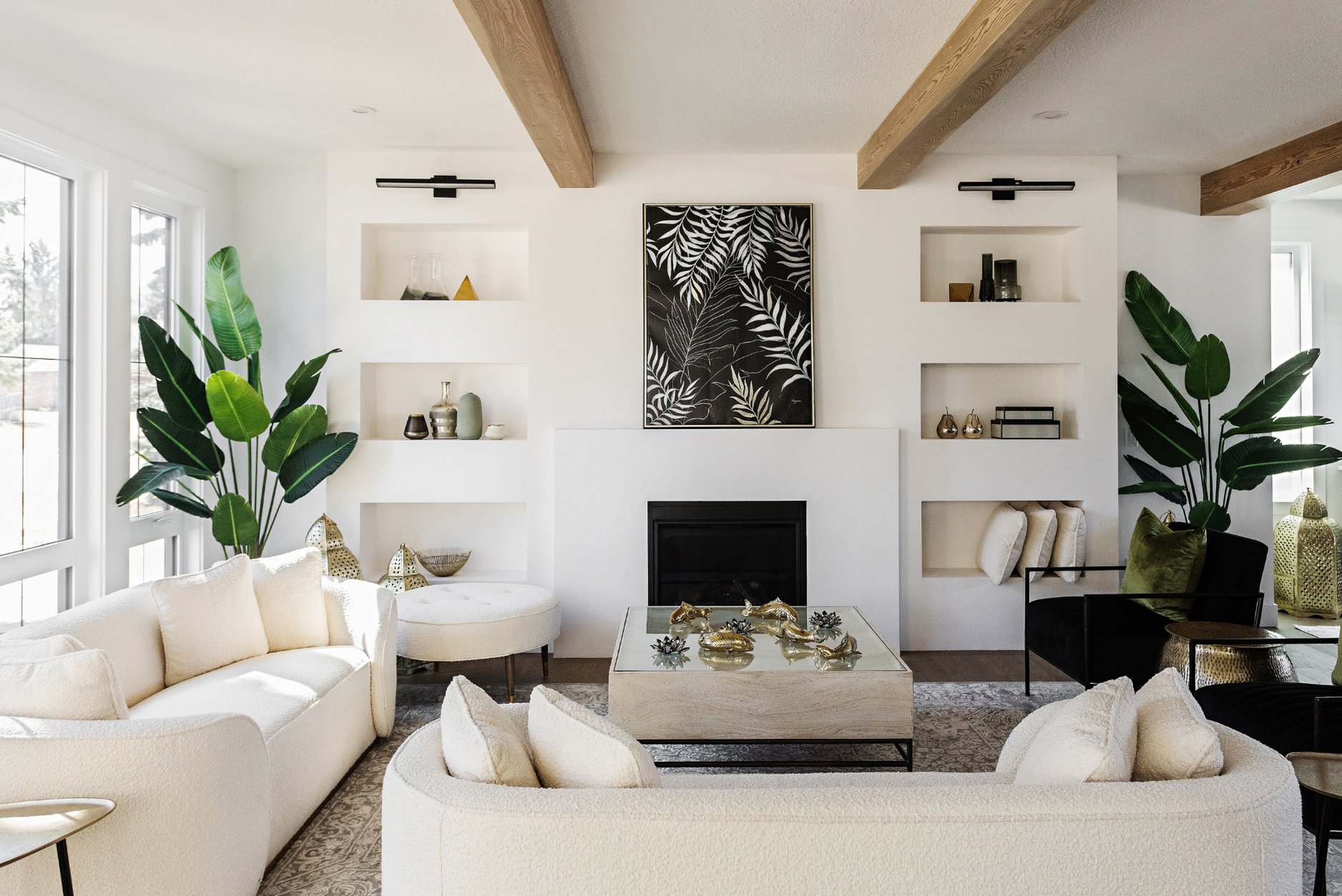 Photo of a white wall with shelf decor and fireplace in living room with white and black furniture