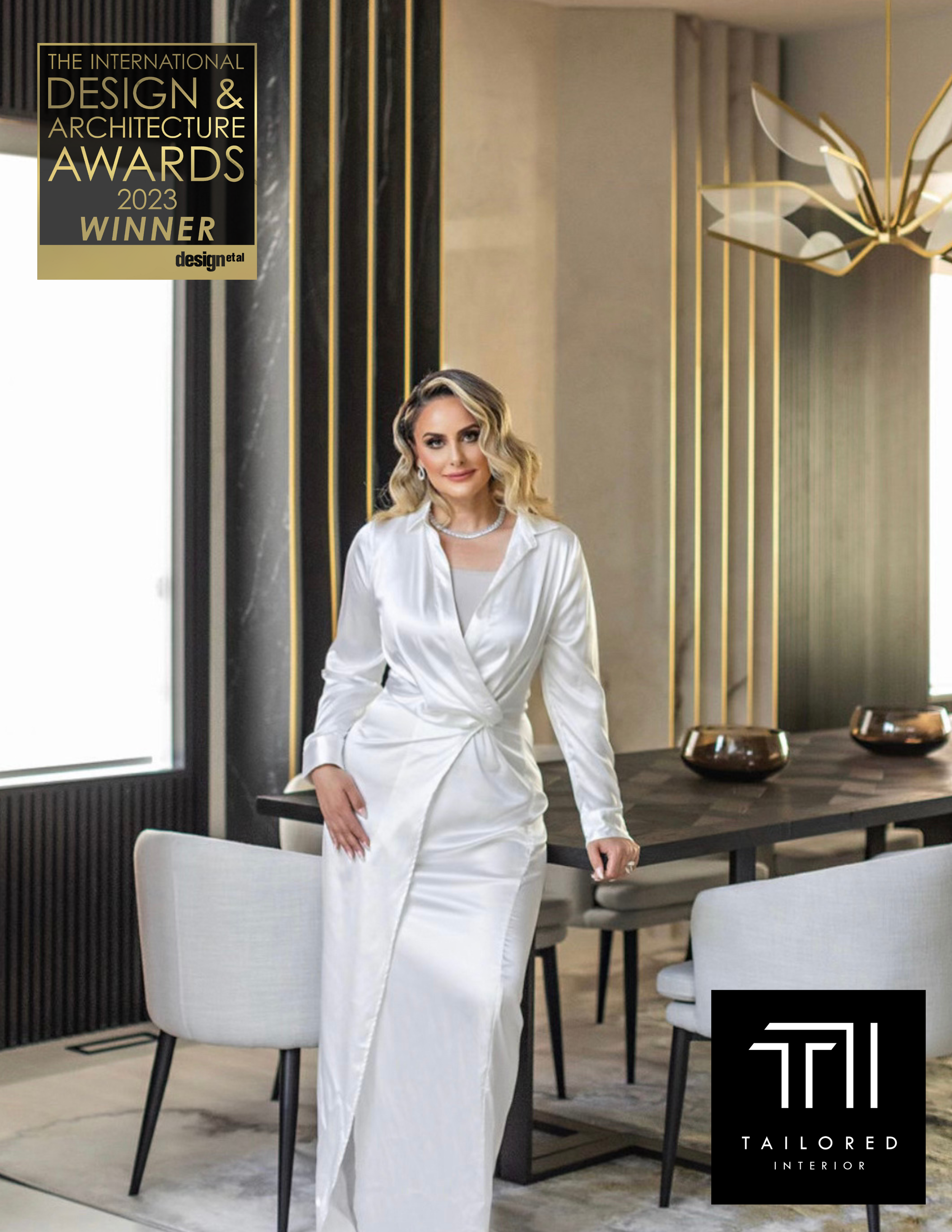 Photo of Aness Handous, a woman in a white silk gown, posing in a modern designed dining room, overlayed with a Design Award logo and Tailored Interior Logo