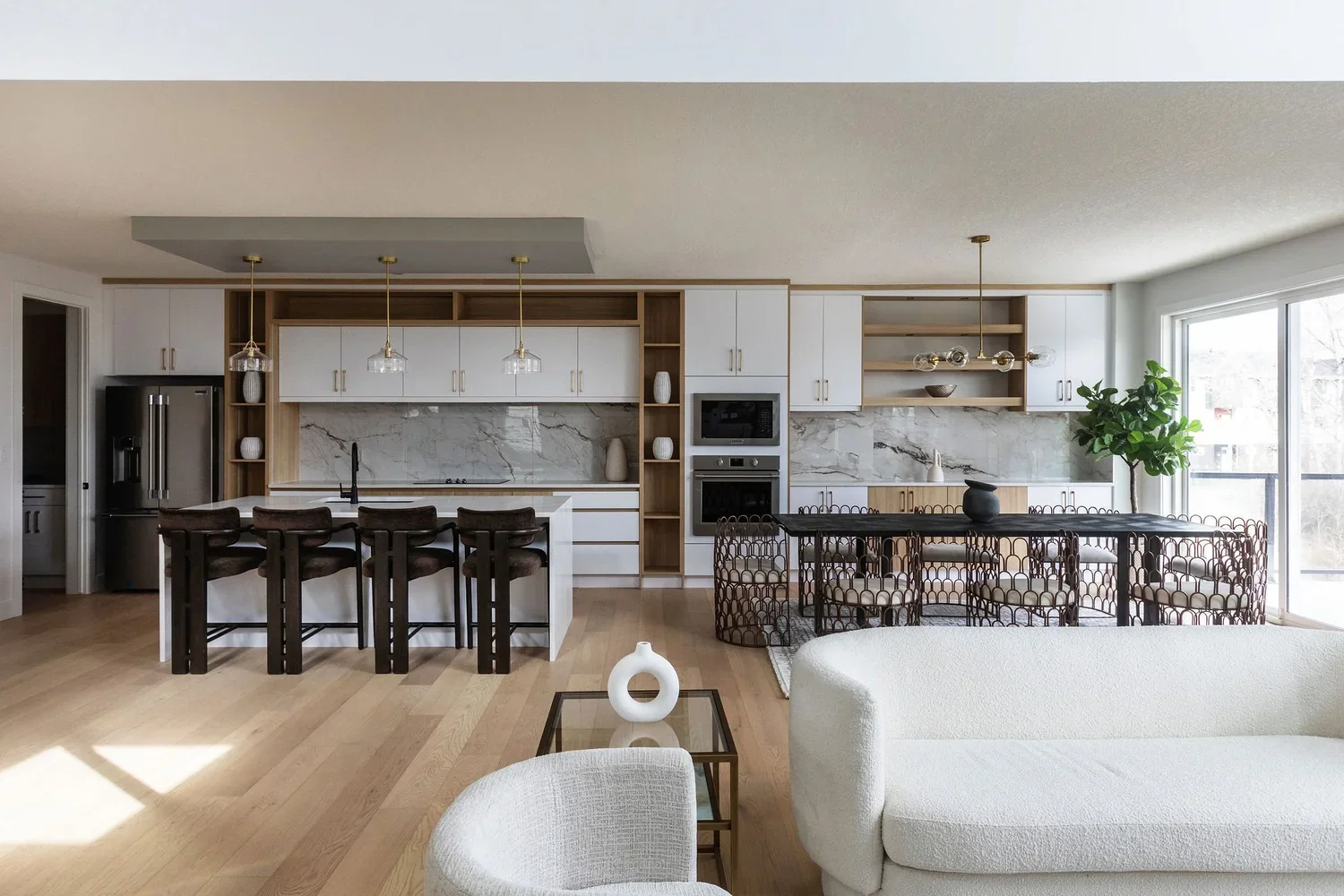 photo of a living room with white sofas with a modern luxury white kitchen and dining room behind