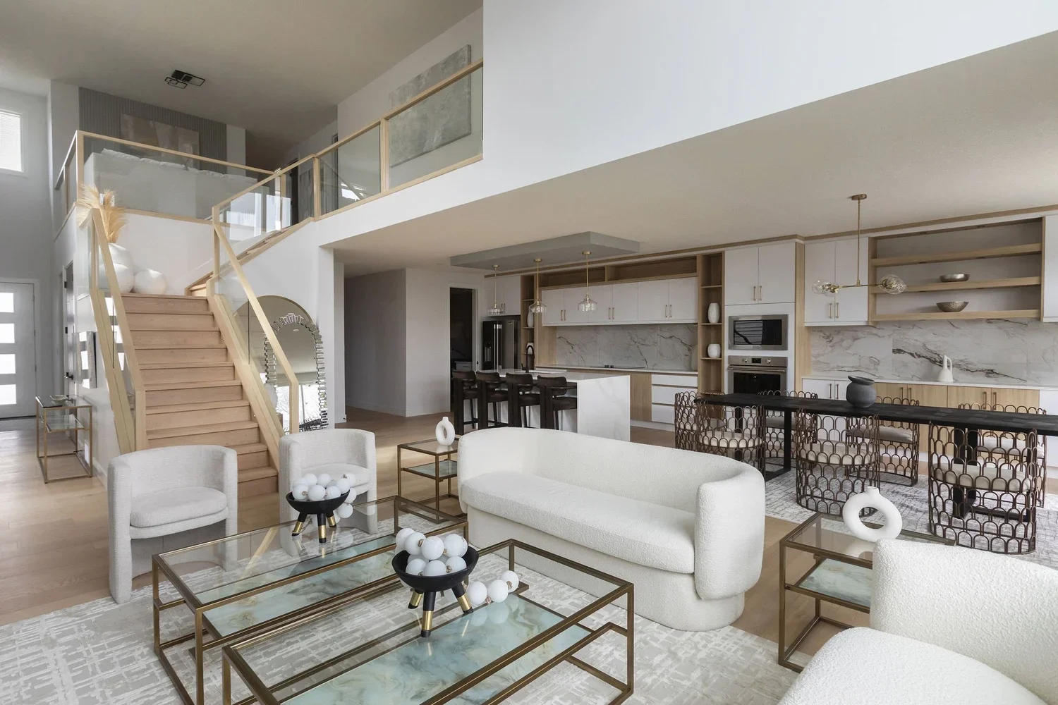Photo of living room renovation cost with white sofas and armchairs around two gold rimmed glass coffee tables with a kitchen in the background