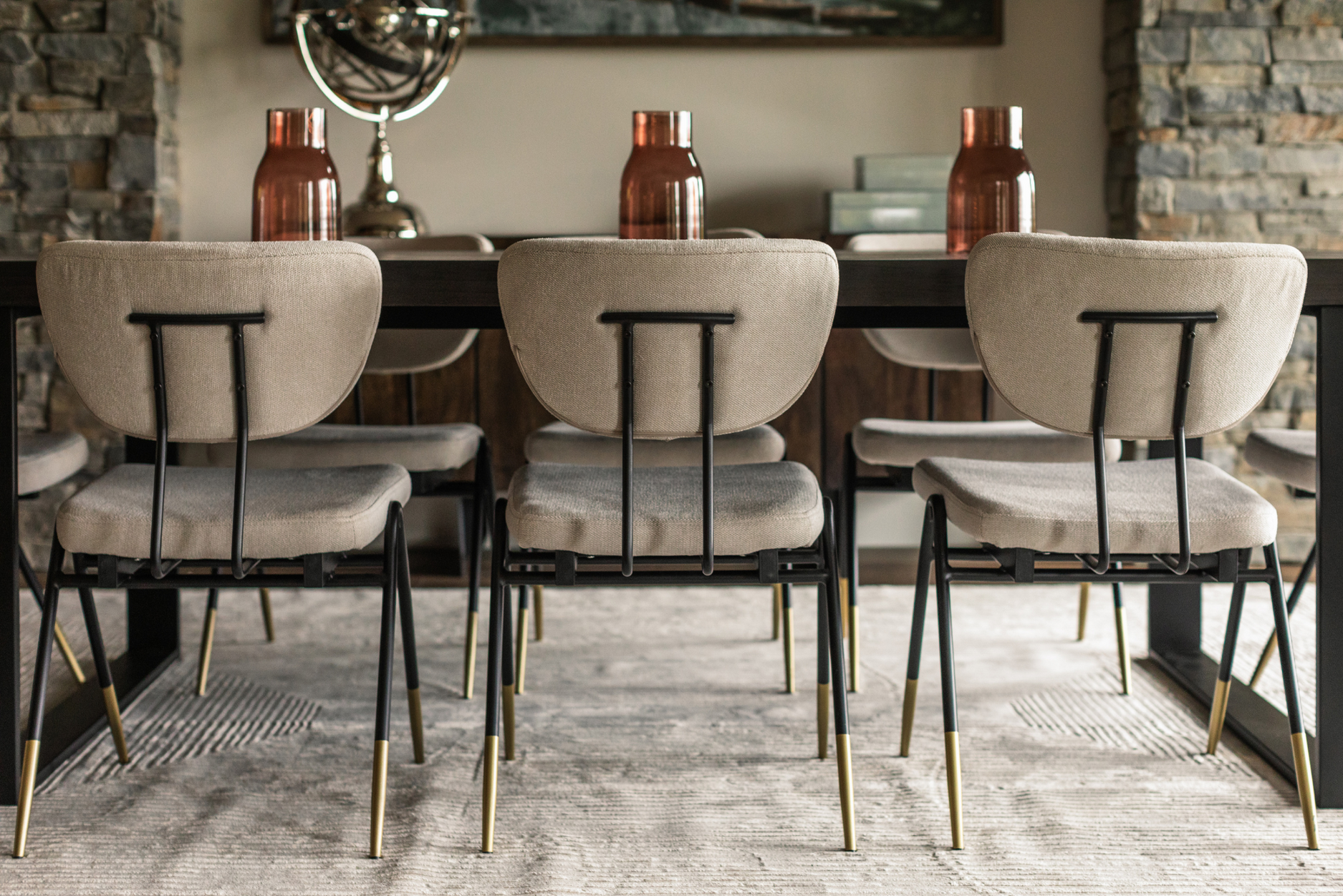 Photo of three beige chairs seated at a wood dining table