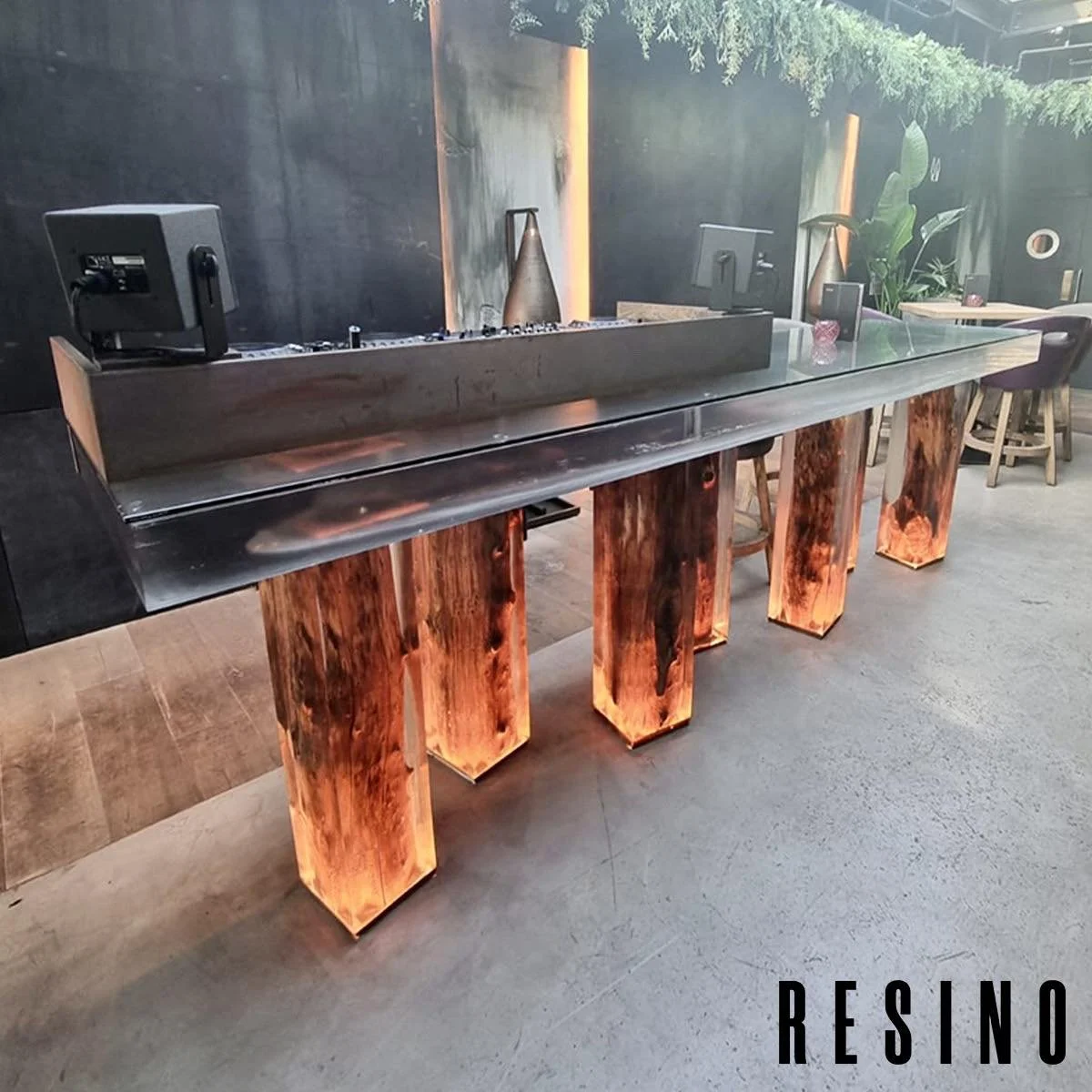 This huge table that doubles up as a DJ booth is made up of a solid cast clear resin top and 7 large tree stumps encased in clear resin!
This was quite the undertaking with the top alone weighing upwards of 350kg and needing to be craned up 7 floors 
