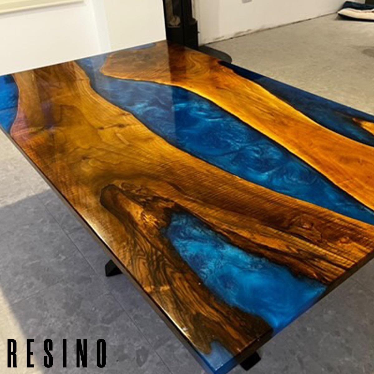 This table has been sat in storage for a little while whilst the owners waited on their new home being finished!
Walnut and blue mica mix resin, black cross over base design, glossy protective finish coat. 
.
.
.
#resinfurniture #rivertables #riverta