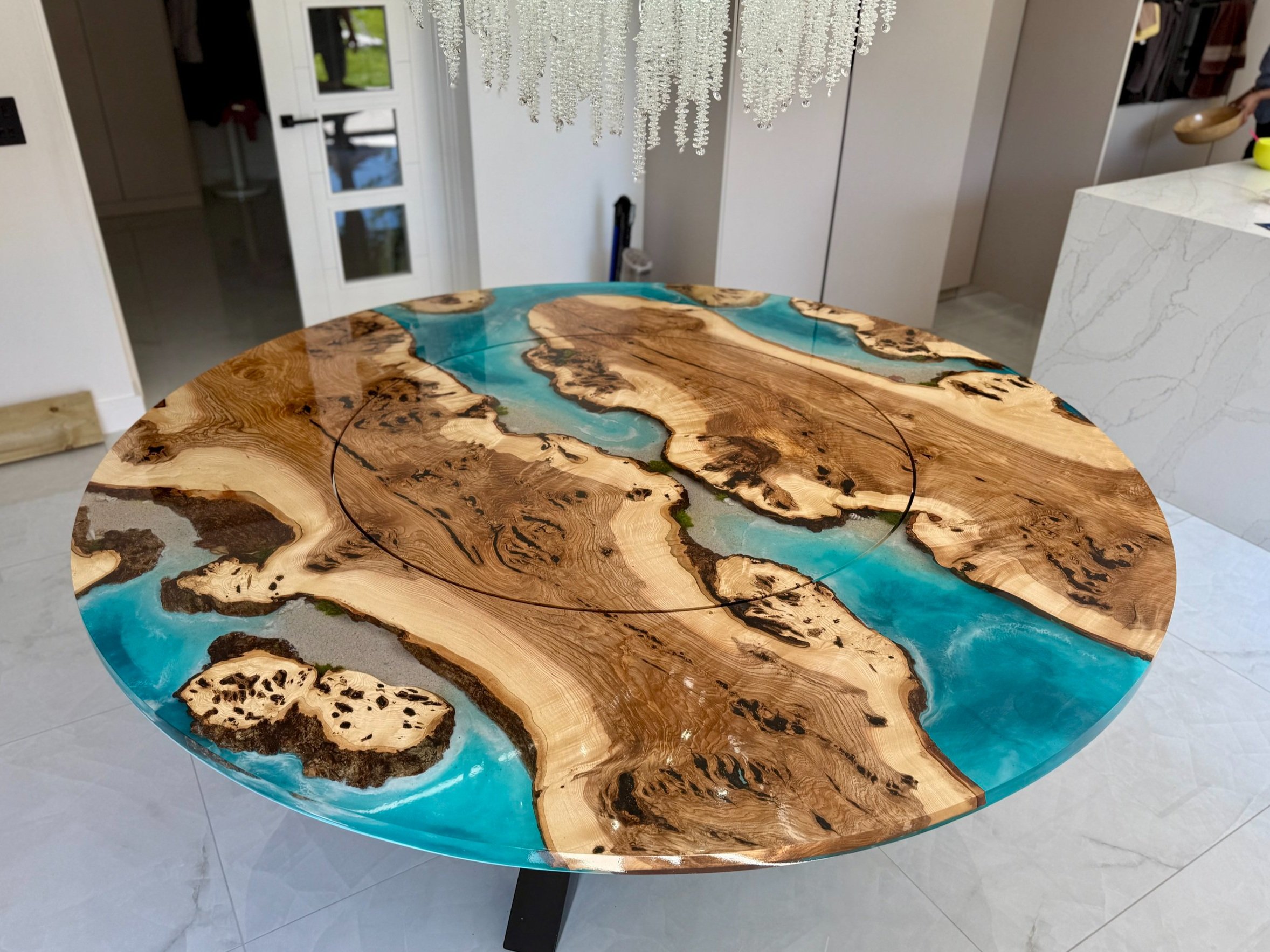 Large round dining table with ocean themed resin sections