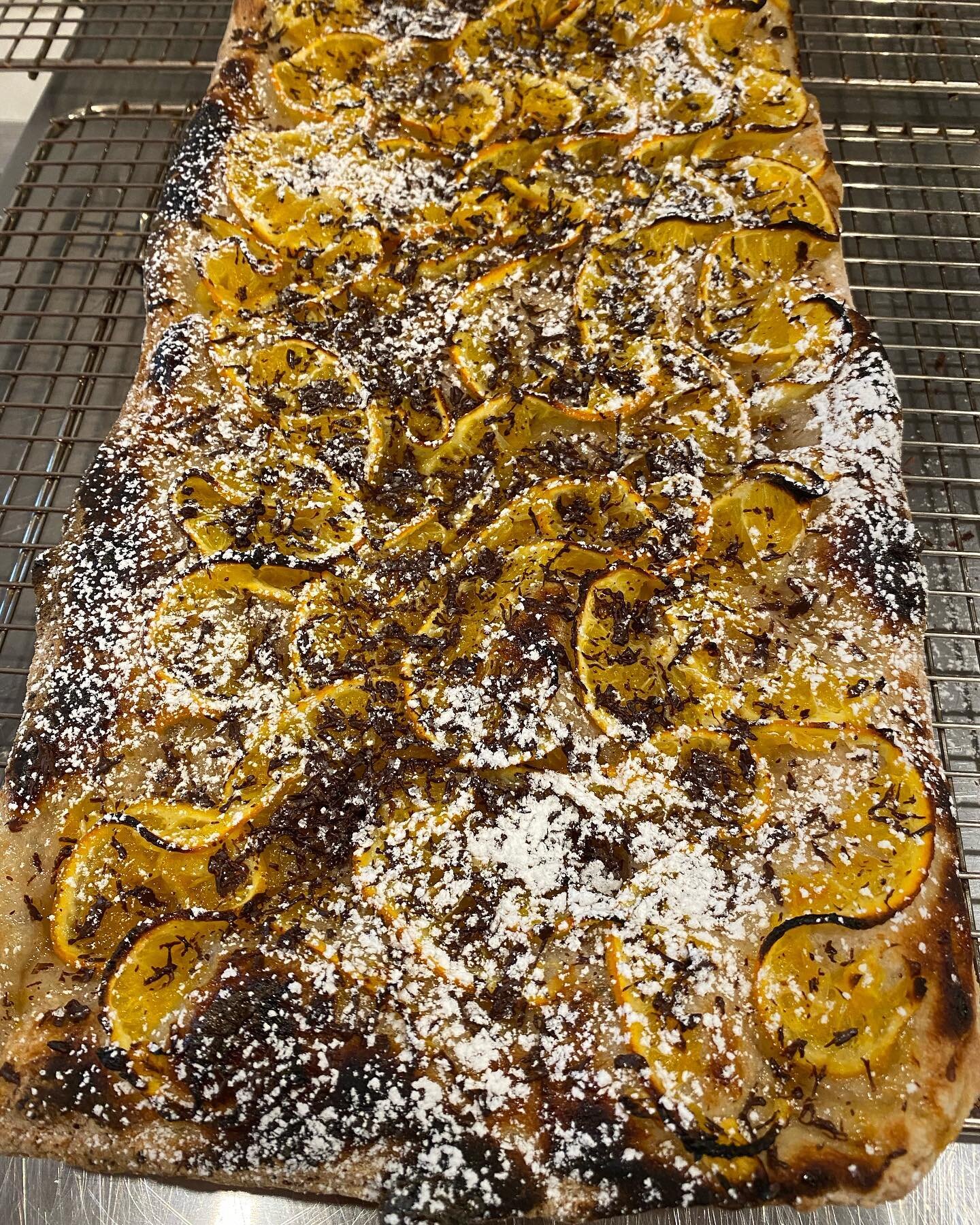 Special Christmas dessert pizza on special today, slices only!

Orange marmalade base, with caramalized oranges, shaved dark chocolate and icing sugar on top 🤤

Come grab a gift card and try a slice!