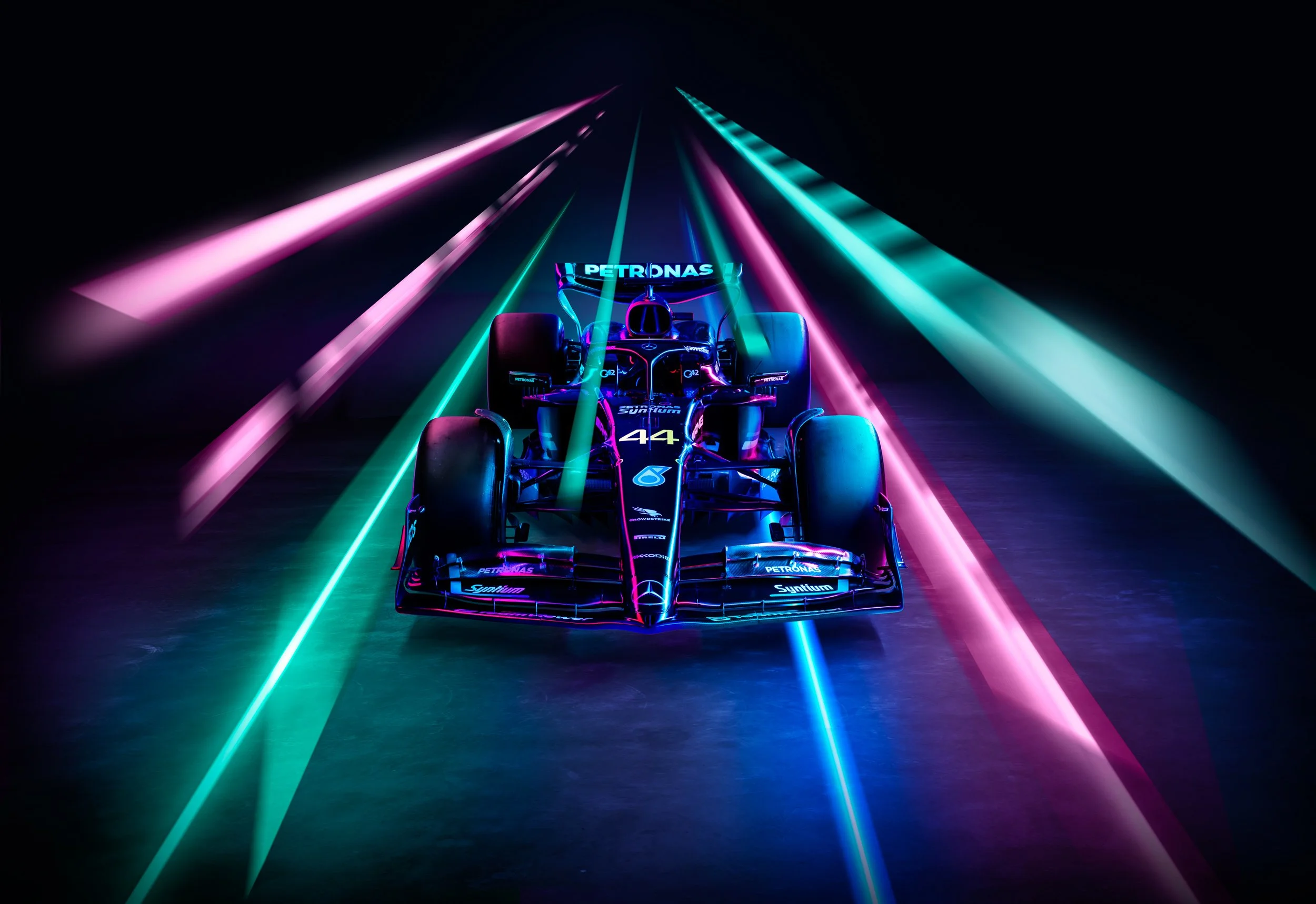 Formula 1 car with neon lights in pink and blue against a dark background