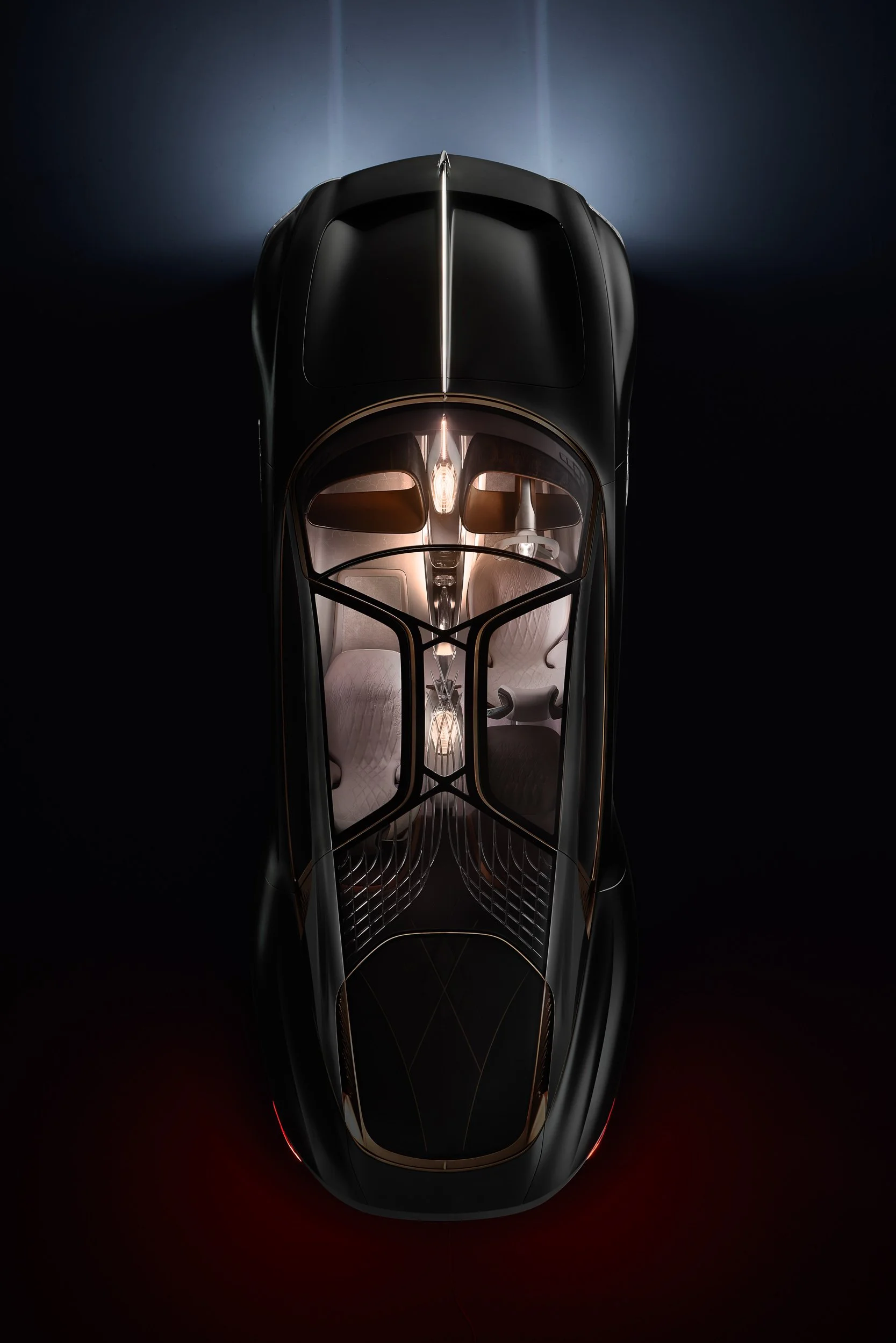 Overhead view of a futuristic black car with illuminated interior, featuring elegant, curved design lines and luxurious seating.