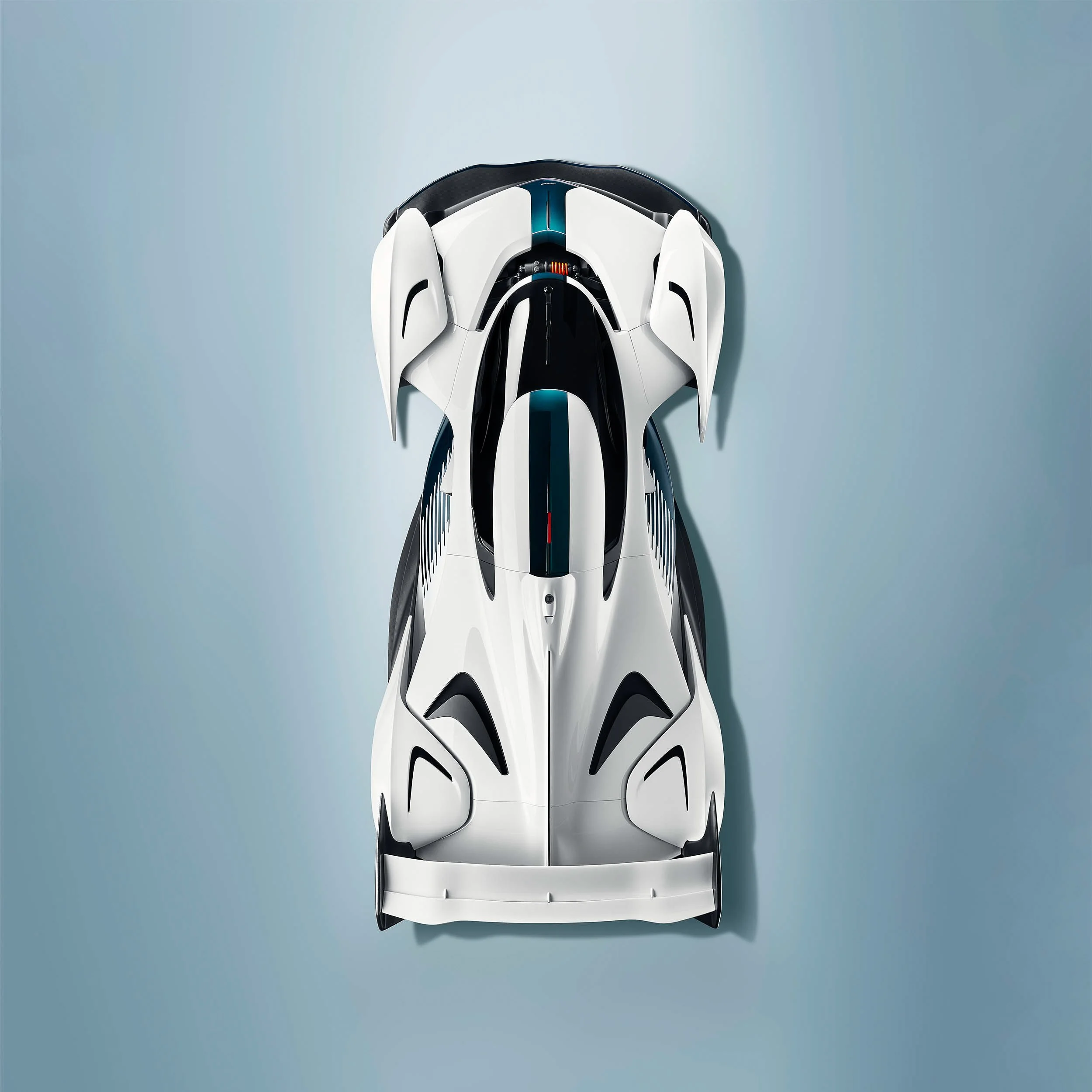 Top view of a futuristic white racing car with aerodynamic design and black accents on a light blue background.